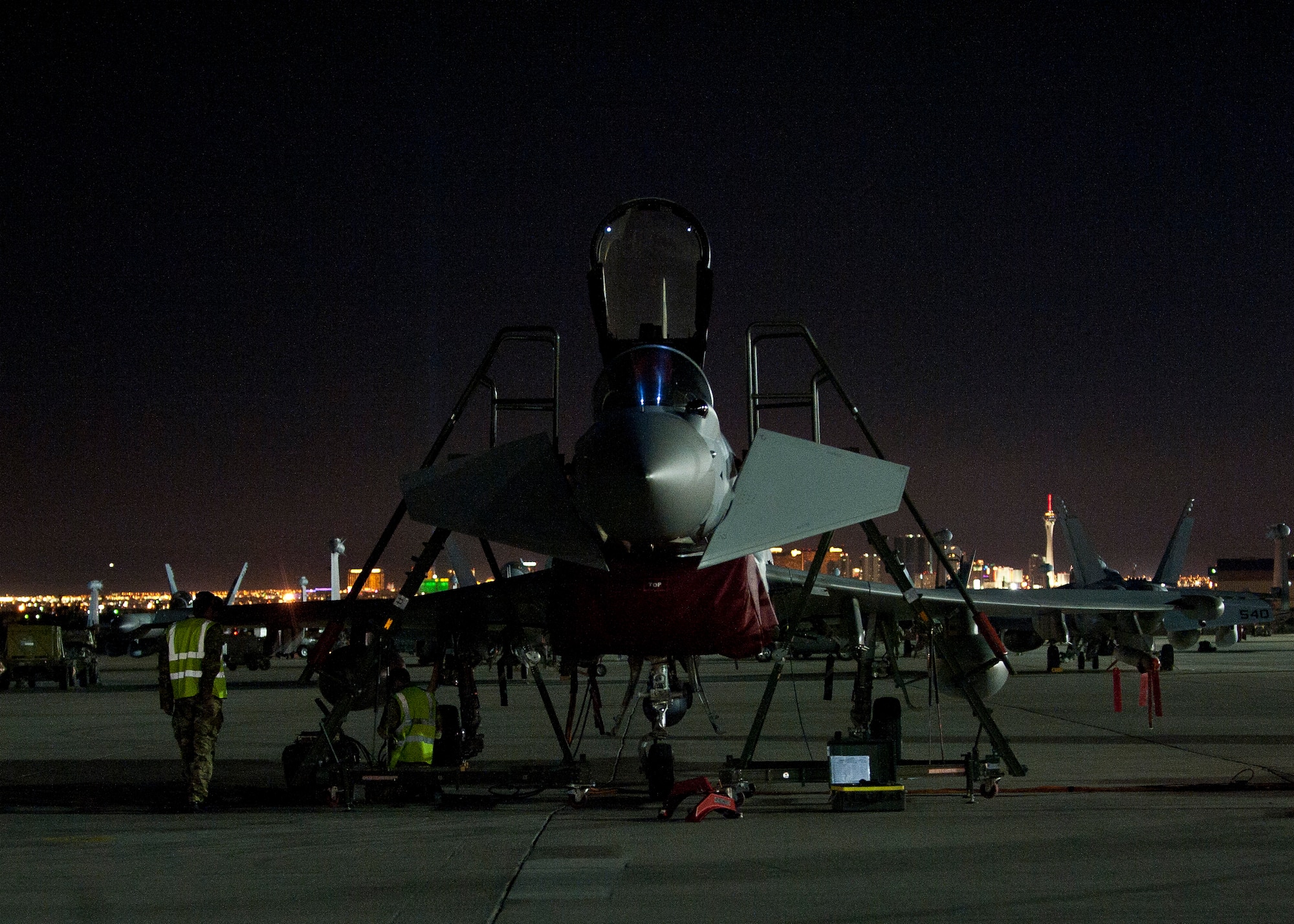 Two Royal Air Force crew chiefs work on a Typhoon FGR4 assigned to 1 (Fighter) Squadron, RAF Lossiemouth, Scotland, during Red Flag 15-1 at Nellis Air Force Base, Nev., Feb. 4, 2015. The Typhoon is a multi-role combat aircraft capable of being deployed in the full spectrum of air operations from air policing to peace support through high-intensity conflict. (U.S. Air Force photo by Staff Sgt. Siuta B. Ika)