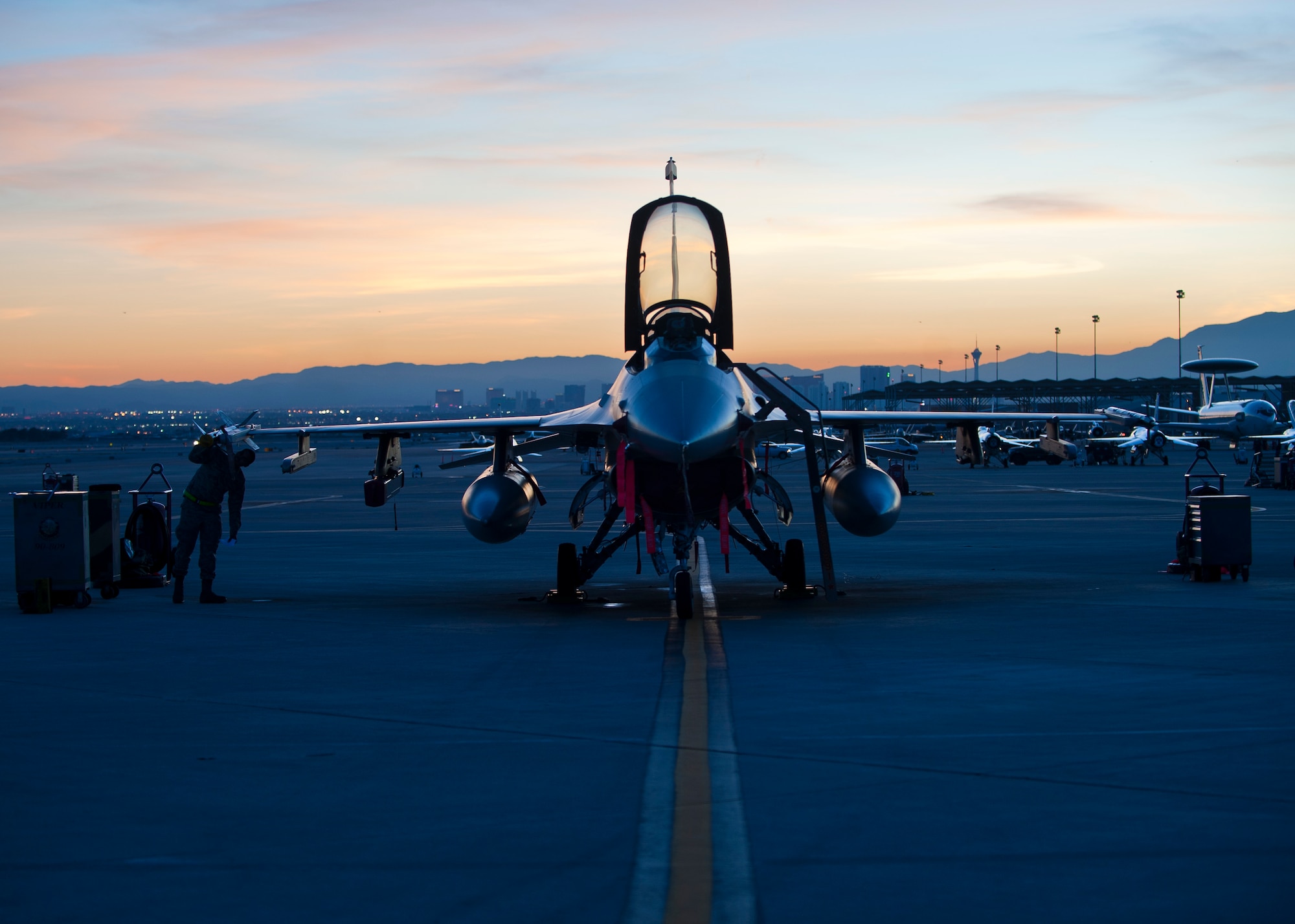 A maintainer from the 57th Aircraft Maintenance Squadron Viper Aircraft Maintenance Unit looks at the wing of an F-16 Fighting Falcon assigned to the 64th Aggressor Squadron during Red Flag 15-1 at Nellis Air Force Base, Nev., Feb. 4, 2015. Maintainers are responsible for overseeing the day-to-day maintenance of aircraft, including diagnosing malfunctions and replacing components, and conducting various inspections to ensure the aircraft is functioning properly. (U.S. Air Force photo by Staff Sgt. Siuta B. Ika)