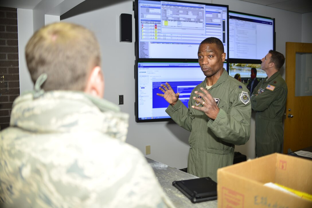 Lt. Colonel Patrick Campbell, 914th Operations Group Commander, Niagara Falls Air Reserve Station, N.Y., briefs Colonel Louis Patriquin, Vice Commander, 22nd Air Force, Dobbins Air Reserve Base, GA. on a new attained media wall which will improve daily operations by transferring information instantaneously between groups on base. Col. Patriquin visited Niagara Falls February 6-8, 2015. (U.S. Air Force photo by Tech. Sgt. Stephanie Sawyer) 