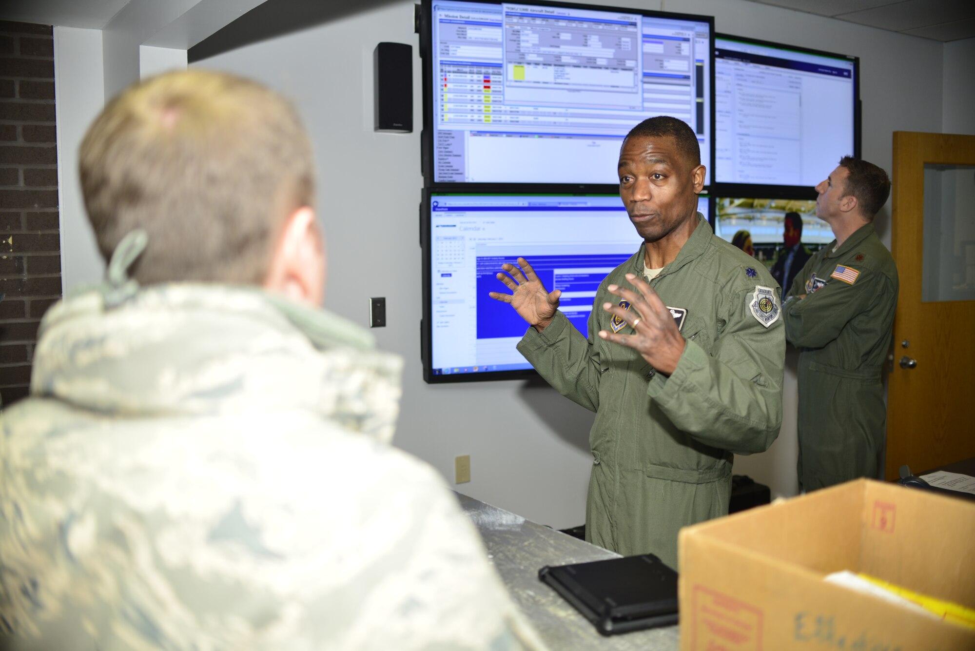 Lt. Colonel Patrick Campbell, 914th Operations Group Commander, Niagara Falls Air Reserve Station, N.Y., briefs Colonel Louis Patriquin, Vice Commander, 22nd Air Force, Dobbins Air Reserve Base, GA. on a new attained media wall which will improve daily operations by transferring information instantaneously between groups on base. Col. Patriquin visited Niagara Falls February 6-8, 2015. (U.S. Air Force photo by Tech. Sgt. Stephanie Sawyer) 