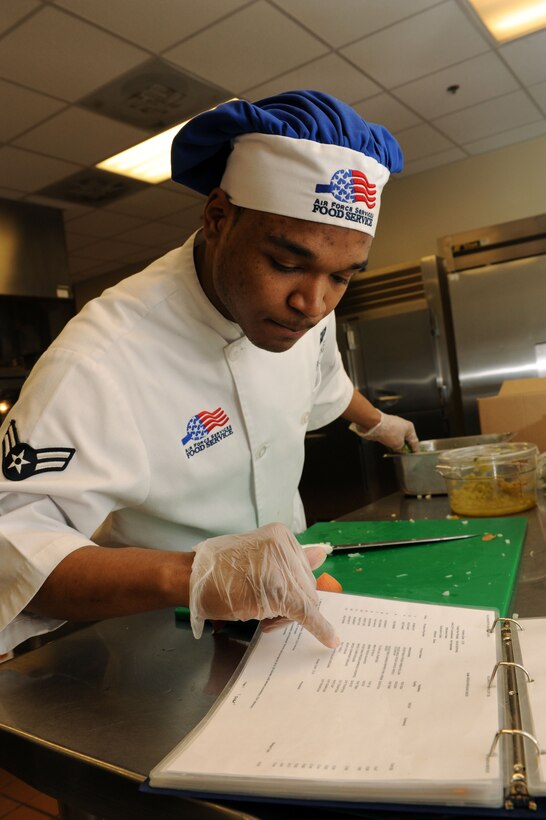 Airman 1st Class Christian Plaskett, 28th Force Support Squadron food service apprentice, checks recipe ingredients during food preparation at the Raider Café at Ellsworth Air Force Base, S.D., Feb. 6, 2015. Plaskett is one of more than 35 dining facility employees who work around the clock to provide meals to Team Ellsworth. (U.S. Air Force photo by Senior Airman Hailey R. Staker/Released)