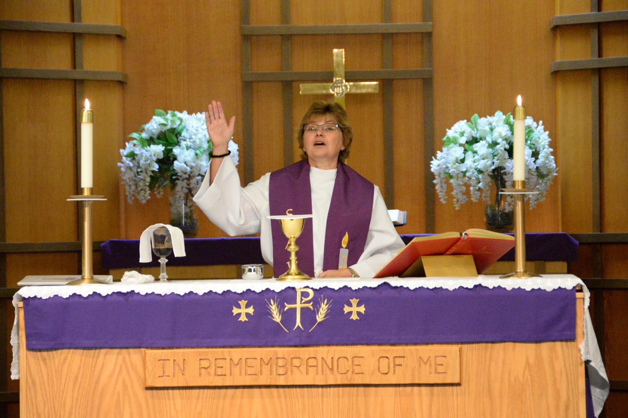 Chaplain (Lt. Col.) Laura Adelia, assigned with the 129th Rescue Wing, leads a worship services at the historic Moffett Chapel, Moffett Federal Airfield, Calif. After two and half years the chapel reopened on Sunday, Dec. 7, 2014, Pearl Harbor Remembrance Day. Through the combined efforts of the Parks Reserve Forces Training Area and the 129th Rescue Wing, resources were found to reopen the chapel to all military, dependents, retires and the local community for religious services. (U.S. California Air National Guard photo by Tech. Sgt. Ray Aquino/Released)