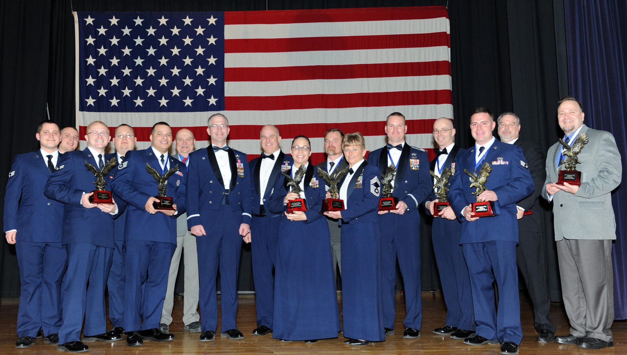 The 2014 annual award winners stand on stage, Feb. 6, with Col. Joel Jackson, 22nd Air Refueling Wing commander, at McConnell Air Force Base, Kan. The banquet was held to recognize some of the wing’s top performers of the year. (U.S. Air Force photo by Airman 1st Class David Bernal Del Agua)