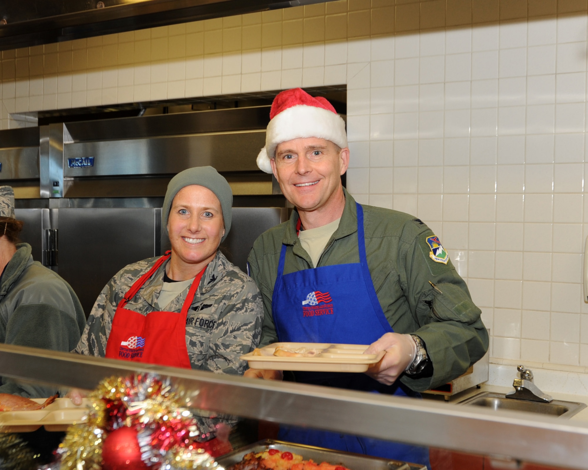 Col. Richard Wedan, 142nd Fighter Wing Commander and Col. Heidi Kjos, 142nd Fighter Wing Medical Group Commander serve holiday lunch to members of the wing, Dec. 07, 2013 at the Portland Air National Guard Base, Ore. (U.S. Air National Guard photo by Master Sgt. Shelly Davison/Released)