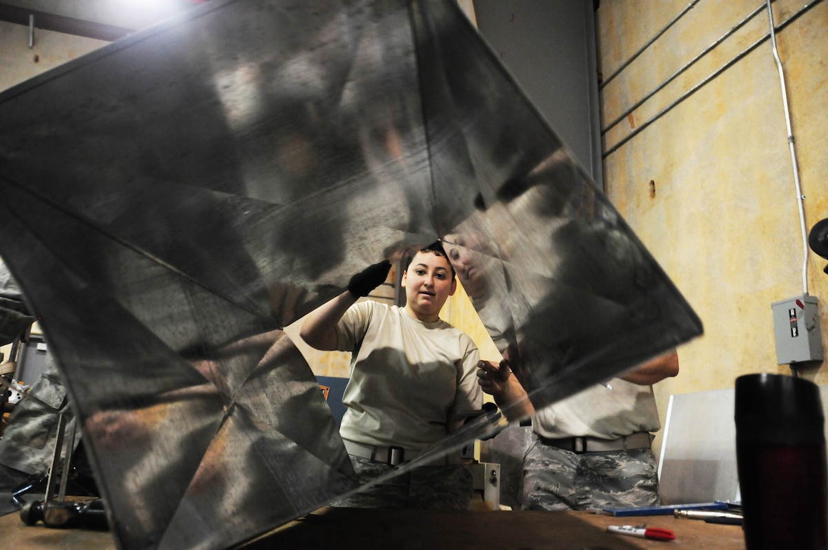 U.S. Air National Guard Airman 1st Class Jessica Ochoa from the 146th Airlift Wing Civil Engineering Squadron moves an air duct at the 554th Red Horse Squadron at Andersen AFB, Guam on February 4, 2015. (U.S. Air National Guard photo by Airman 1st Class Madeleine Richards/Released)