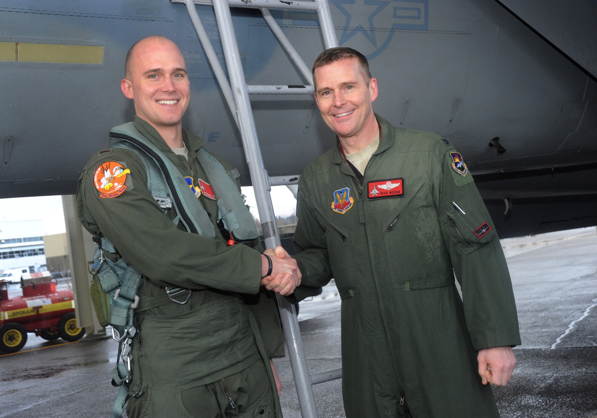 Air National Guard Col. Richard W. Wedan, right, exchanges a word with his son, Air Force 2nd Lt. Steven Wedan, after they flew in formation together Feb. 7, 2015, at Portland Air National Guard Base, Ore. The flight was Col. Wedan’s last in an F-15 Eagle and as commander of the 142nd Fighter Wing. Lt. Wedan flew in the backseat of Col. Wedan’s wingman jet, piloted by Col. Paul T. Fitzgerald, 142nd Fighter Wing Vice Commander. Col. Fitzgerald assumed command of the wing during a ceremony held here Feb. 7. Lt. Wedan is scheduled to graduate from Air Force pilot training next week. (U.S. Air National Guard photo by Tech. Sgt. John Hughel, 142nd Fighter Wing Public Affairs/Released)