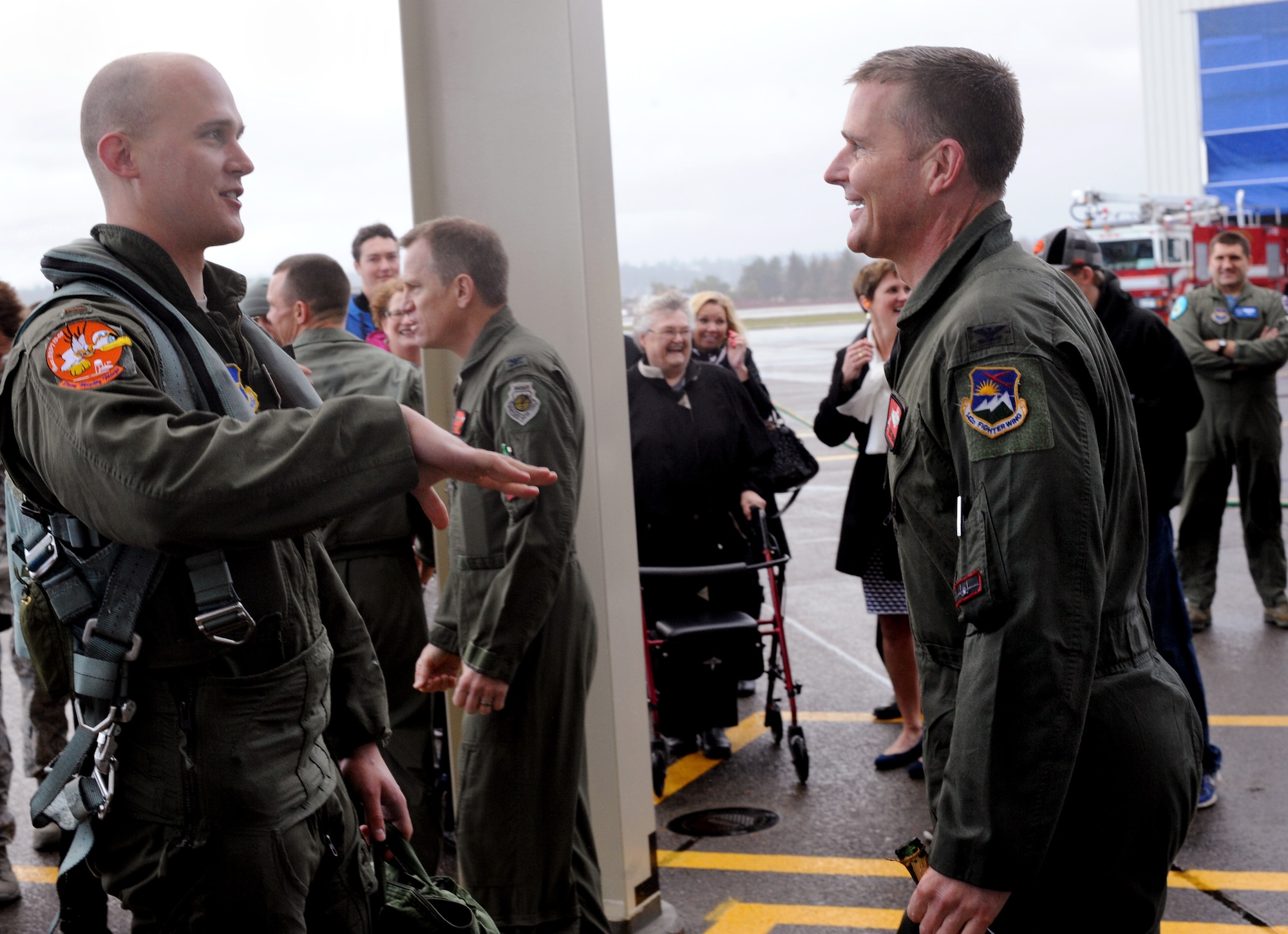 Air National Guard Col. Richard W. Wedan, right, exchanges a word with his son, Air Force 2nd Lt. Steven Wedan, after they flew in formation together Feb. 7, 2015, at Portland Air National Guard Base, Ore. The flight was Col. Wedan’s last in an F-15 Eagle and as commander of the 142nd Fighter Wing. Lt. Wedan flew in the backseat of Col. Wedan’s wingman jet, piloted by Col. Paul T. Fitzgerald, 142nd Fighter Wing Vice Commander. Col. Fitzgerald assumed command of the wing during a ceremony held here Feb. 7. Lt. Wedan is scheduled to graduate from Air Force pilot training next week. (U.S. Air National Guard photo by Tech. Sgt. John Hughel, 142nd Fighter Wing Public Affairs/Released)