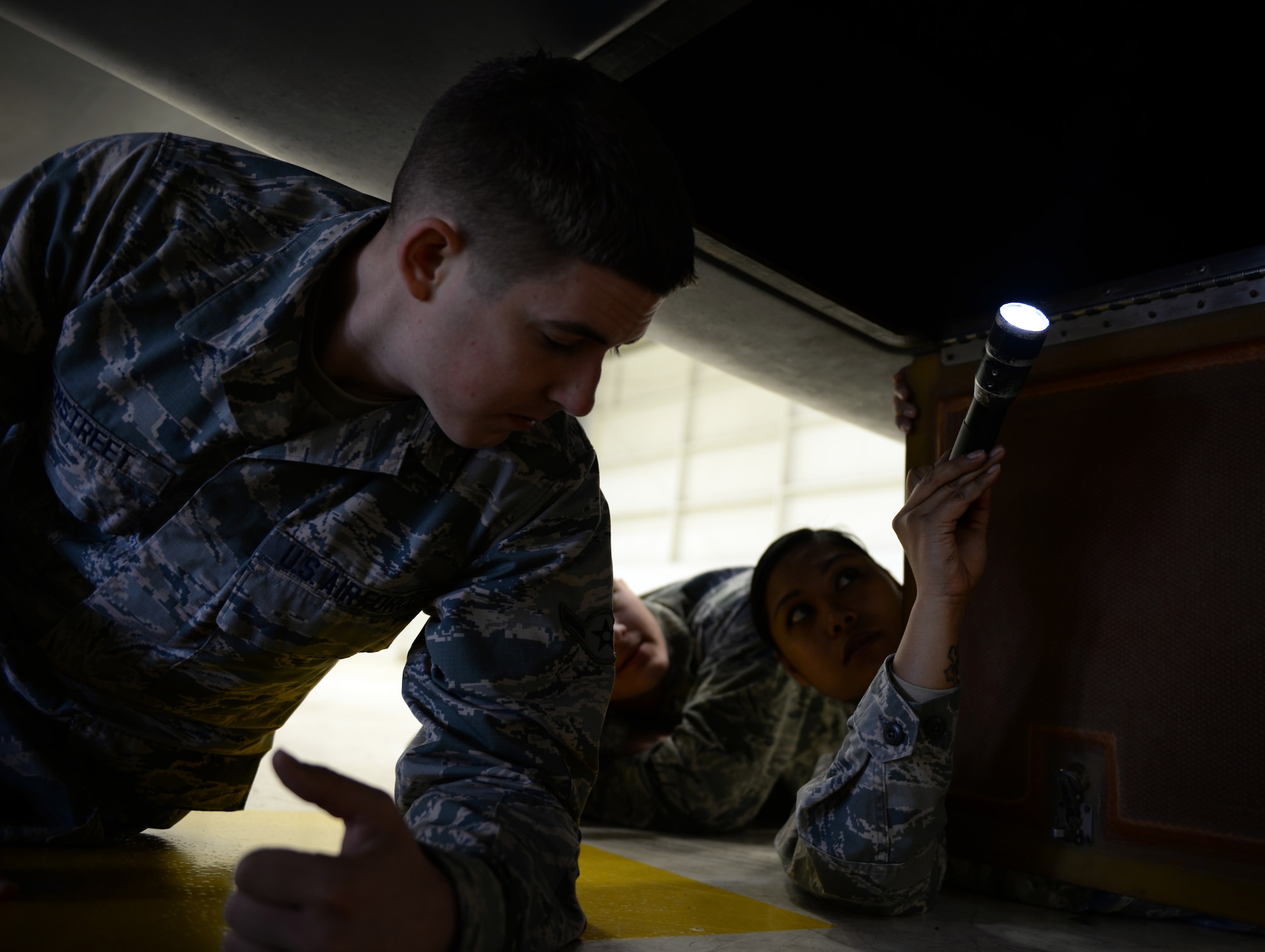 Tech. Sgt. Maureen Madamba (right), 372nd Training Squadron Detachment 21 maintenance instructor, inspects the interior of a RQ-4 Global Hawk with Airman Murray Hemstreet , 372nd TRS Detachment 21, student, Jan. 20, 2015, at Beale Air Force Base, Calif. Hemstreet is one of the first students to attend the  RQ-4 remotely piloted aircraft maintenance course taught at Beale. (U.S. Air Force photo by Senior Airman Bobby Cummings/Released)
