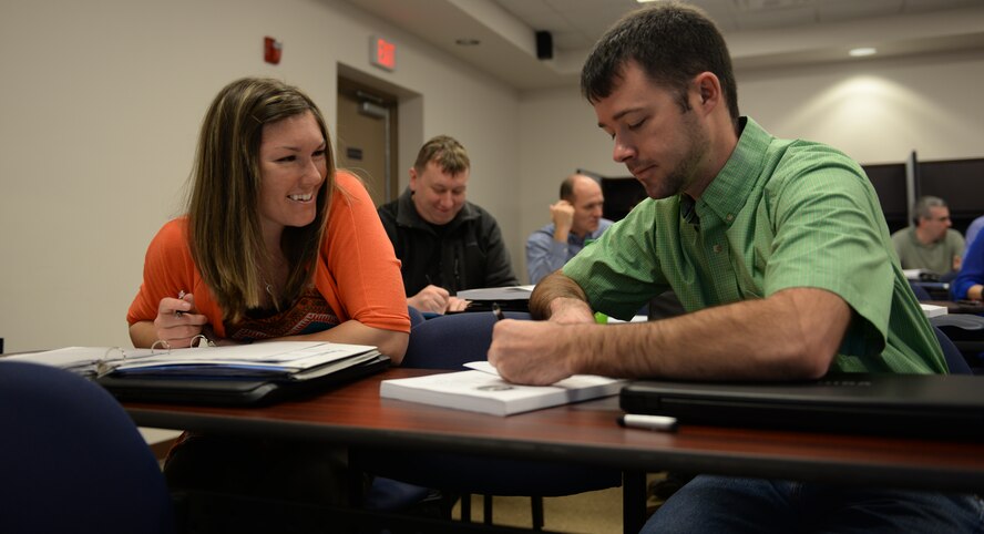 U.S. Air Force Senior Airman Tiffany Williams, 74th Aircraft Maintenance Unit combat oriented supply operations, left, and Staff Sgt. Benjamin Whitfield, 41st Helicopter Maintenance Unit weapons team chief, converse Feb. 10, 2015, at Moody Air Force Base, Ga. Attendees were split up into pairs to discuss their introduction presentations. (U.S. Air Force photo by Airman Greg Nash/Released)