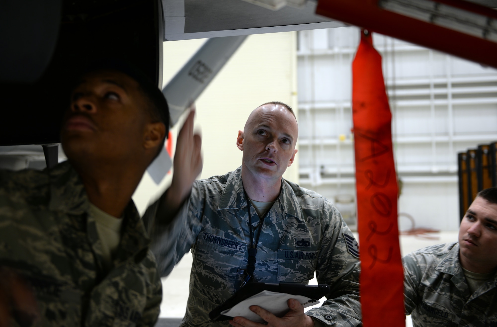 Tech. Sgt. Randy Thornsberry Jr. (Center), 372nd Training Squadron Detachment 21, maintenance instructor, instructs his students during a maintenance inspection of an RQ-4 Global Hawk  Jan. 20, 2015, at Beale Air Force Base, Calif. Thornsberry is tasked with teaching the first class of the RQ-4 remotely piloted aircraft maintenance course. (U.S. Air Force photo by Senior Airman Bobby Cummings/Released)