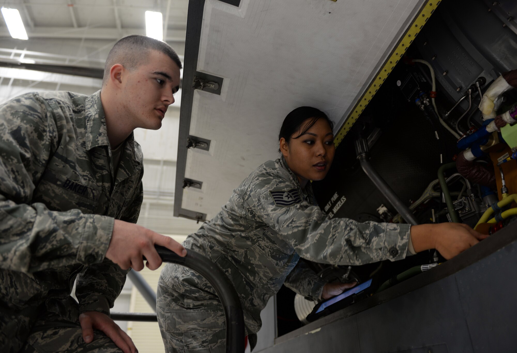 Tech. Sgt. Maureen Madamba (right), 372nd Training Squadron Detachment 21 maintenance instructor, instructs Airman Basic Lain Baker, 372nd TRS Detachment 21 student, how to properly inspect interior components of a RQ-4 Global Hawk Jan. 20, 2015, at Beale Air Force Base, Calif. Madamba is tasked with teaching the first class of the RQ-4 remotely piloted aircraft maintenance course. (U.S. Air Force photo by Senior Airman Bobby Cummings/Released)