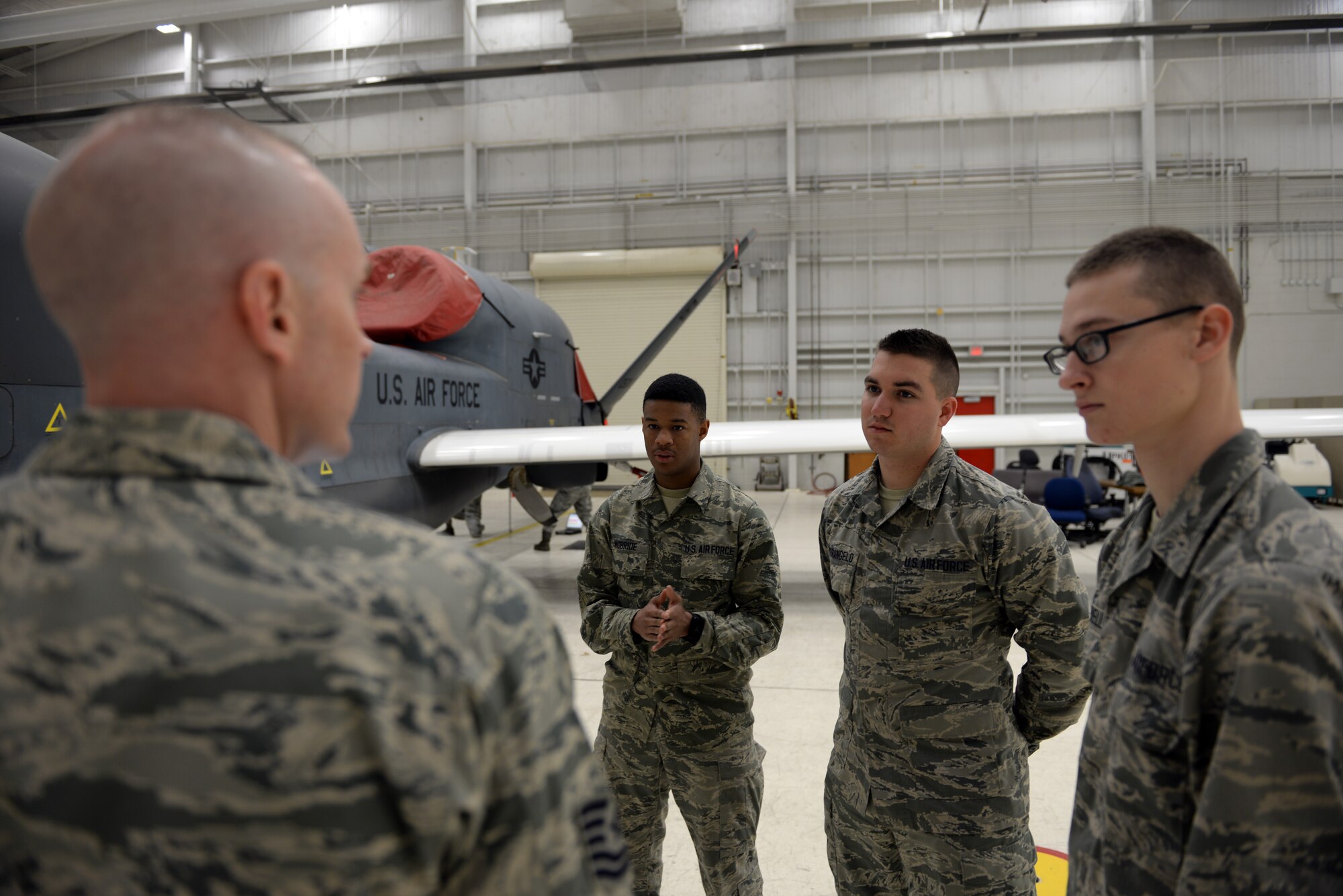 Airmen with the 372nd Training Squadron Detachment 21 receive guidance from Tech. Sgt. Randy Thornsberry Jr., 372nd TRS Detachment 21 maintenance instructor, during a maintenance inspection of an RQ-4 Global Hawk Jan. 20, 2015, at Beale Air Force Base, Calif. The Airmen are the first students to attend the RQ-4 remotely piloted aircraft maintenance course taught at Beale. (U.S. Air Force photo by Senior Airman Bobby Cummings/Released)
