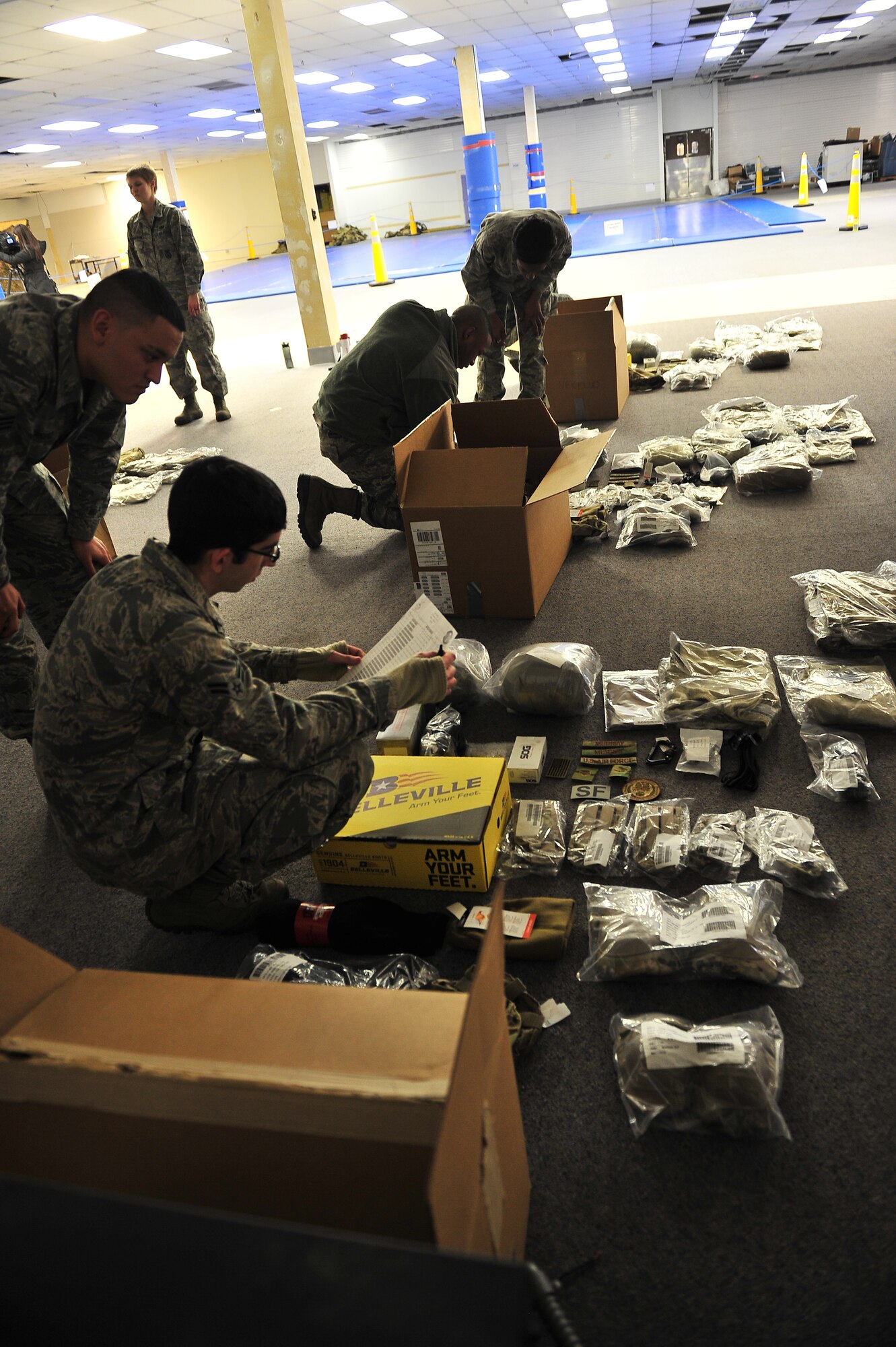 Members of the 91st Security Forces Group and the 5th Security Forces Squadron receive their new Operational Camouflage Pattern uniform on Minot Air Force Base, N.D., Feb. 2, 2014. All Security Forces members in Air Force Global Strike Command will receive the new uniform, with an official wear date of Feb. 9, 2015. (U.S. Air Force photo/Senior Airman Brittany Y. Bateman)