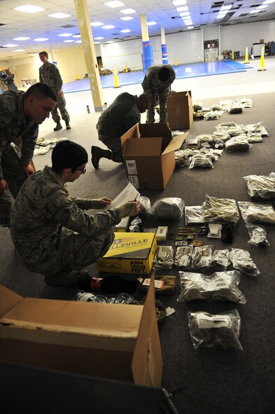 Members of the 91st Security Forces Group and the 5th Security Forces Squadron receive their new Operational Camouflage Pattern uniform on Minot Air Force Base, N.D., Feb. 2, 2014. All Security Forces members in Air Force Global Strike Command will receive the new uniform, with an official wear date of Feb. 9, 2015. (U.S. Air Force photo/Senior Airman Brittany Y. Bateman)