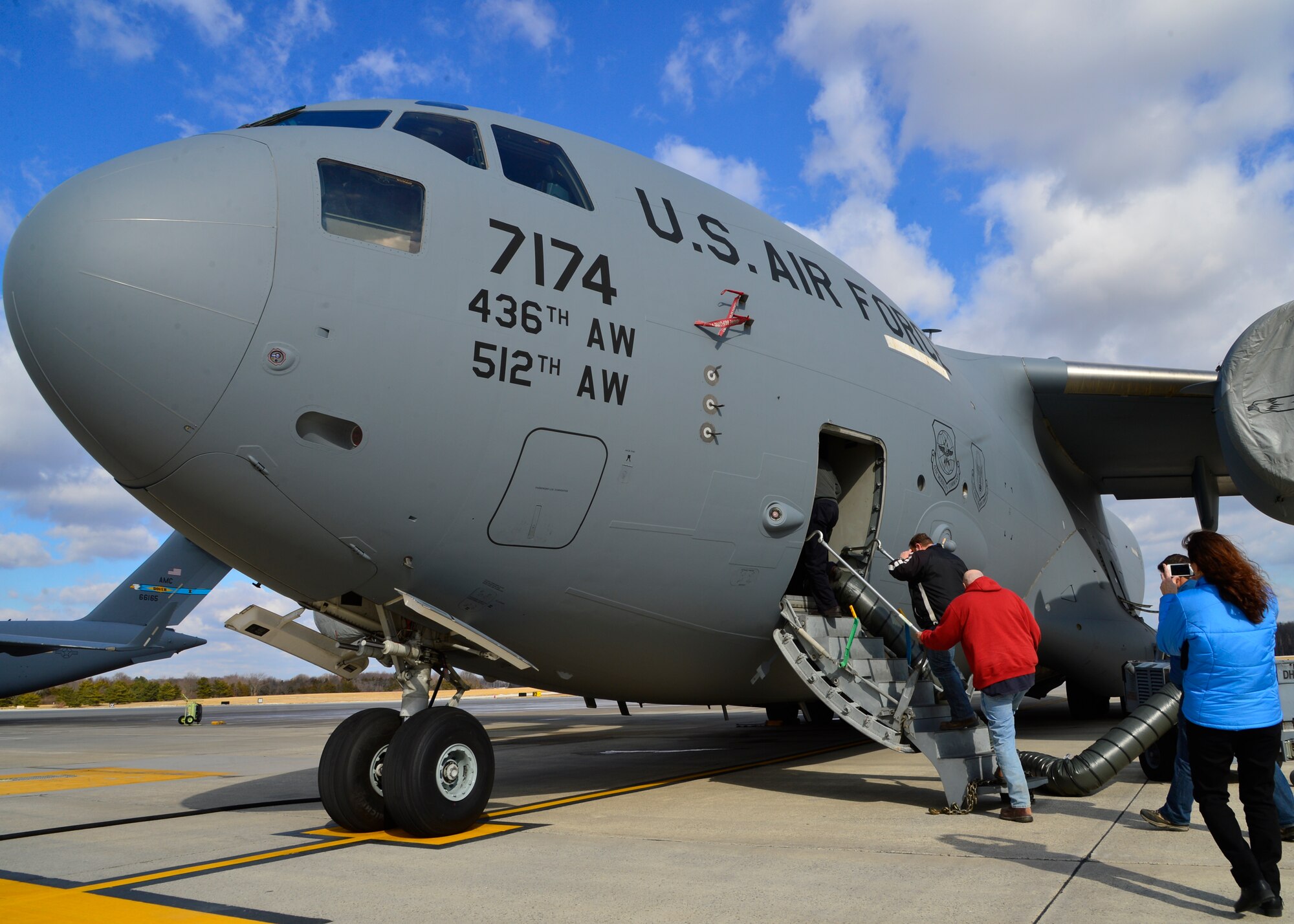 Civilian contractors board a C-17A Globemaster III during a tour of the aircraft Jan. 30, 2015, at Dover Air Force Base, Del. The contractors are set to begin runway renovations scheduled for completion in June 2016. (U.S. Air Force photo/Airman 1st Class William Johnson)