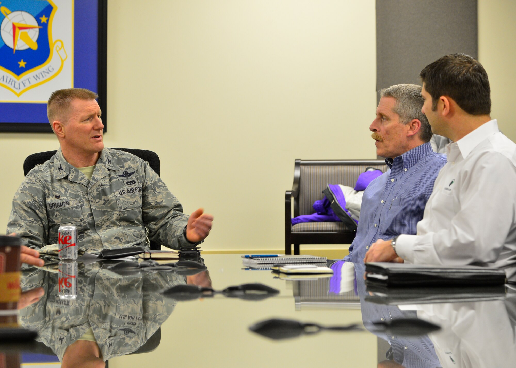 Col. Michael Grismer, 436th Airlift Wing commander, speaks to Douglas Marquart, Versar senior project manager, during a briefing Jan. 30, 2015, at Dover Air Force Base, Del. Grismer held a briefing to give an in-depth view of the Team Dover mission to contractors who will be conducting renovation work on runway 01-19. (U.S. Air Force photo/Airman 1st Class William Johnson)