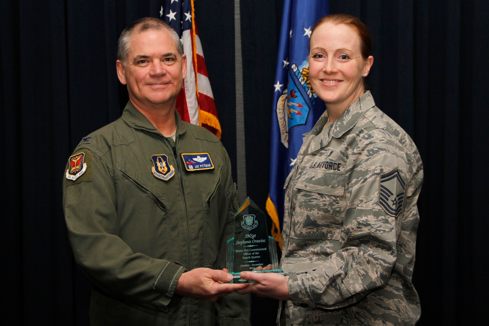 PETERSON AIR FORCE BASE, Colo. Senior Master Sgt. Stephanie Orawiec, 302nd Aeromedical Staging Squadron superintendent, was selected as the senior non-commissioned officer of the 4th quarter for 2014 on February 8 here. Col. Jay Pittman, 302nd Airlift Wing commander and Chief Master Sgt. Otis Jones, 302nd Airlift Wing command chief recognized the quarterly award winners during the February Unit Training Assembly ceremony. (U.S. Air Force photo/Staff Sgt. Nathan Federico)