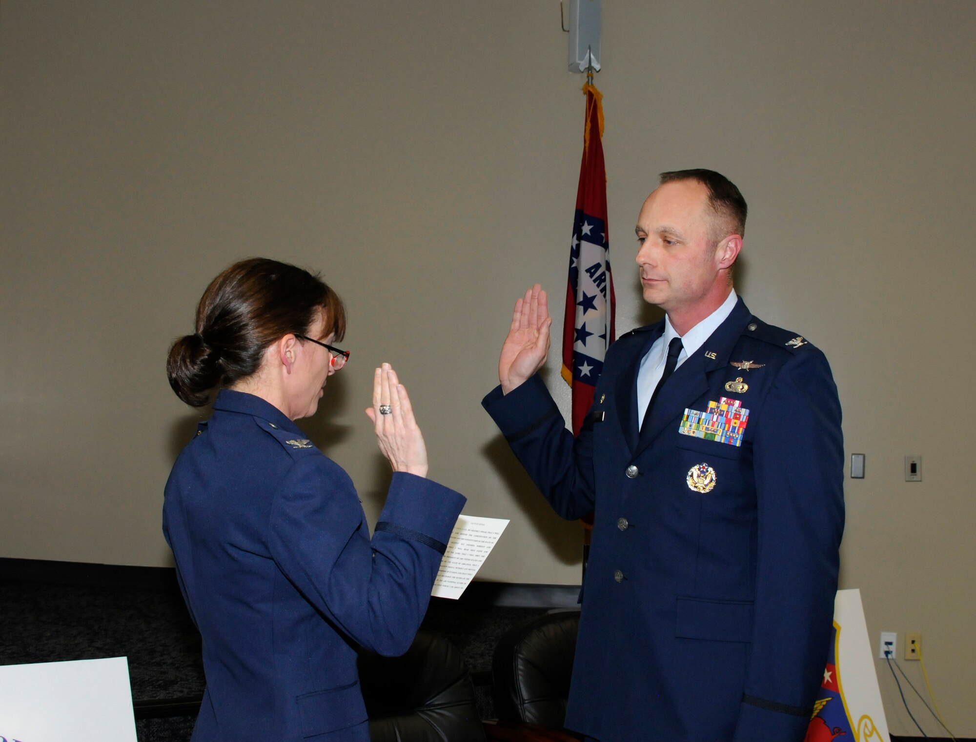 Col. Paige I. Kinney administers the reaffirmation oath to Col. Robert I. Kinney, 188th Intelligence, Surveillance and Reconnaissance Group commander, after promoting him to his present rank during a formal promotion ceremony held Feb. 8, 2015 at Ebbing Air National Guard Base, Fort Smith, Ark. Robert Kinney joined the Air National Guard in 1990 and has spent time in various positions throughout the country in the intelligence career field. The ceremony was presided by his wife, Paige Kinney, director of Intelligence, Surveillance and Reconnaissance at the Continental U.S. North American Aerospace Defense Command Region, 1st Air Force, Air Forces Northern, Tyndall Air Force Base, Fla. (U.S. Air National Guard photo by Staff Sgt. Hannah Dickerson/released)