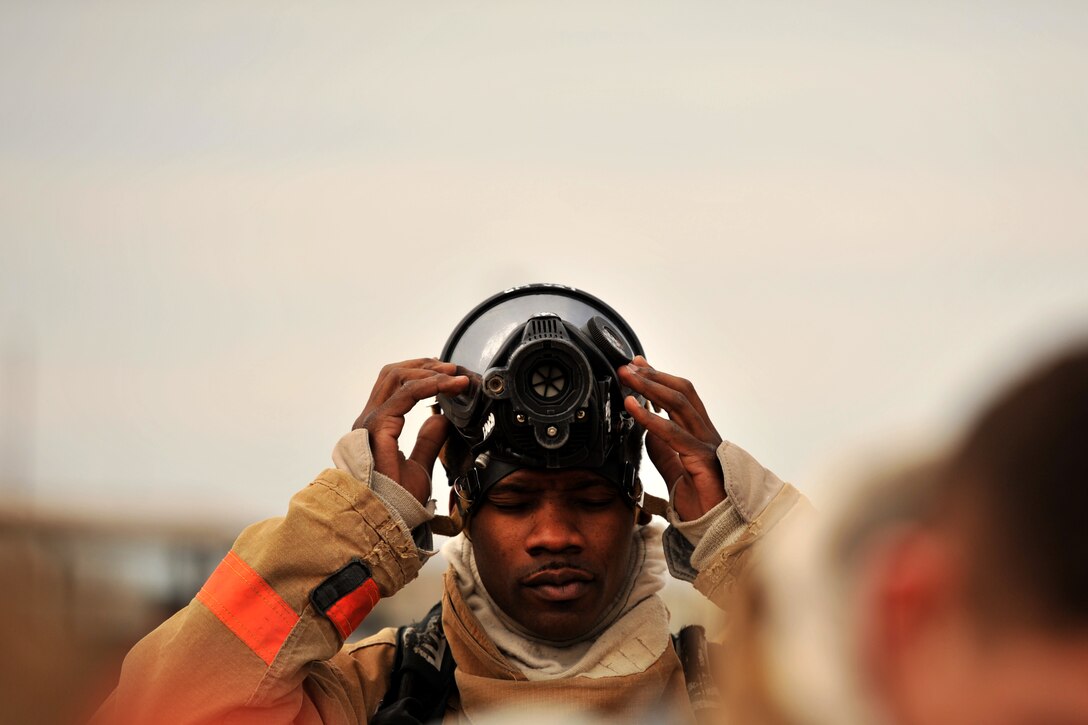 GOODFELLOW AIR FORCE BASE, Texas – Airman 1st Class Onnie O. McSpadden, 127th Michigan Air National Guard firefighting apprentice, readies his gas mask in preparation for firefighting training, Feb. 3. The air becomes thick with smoke and heat around the simulated burners, requiring the students to use oxygen tanks to breathe.
(U.S. Air Force photo/ Senior Airman Scott Jackson)
