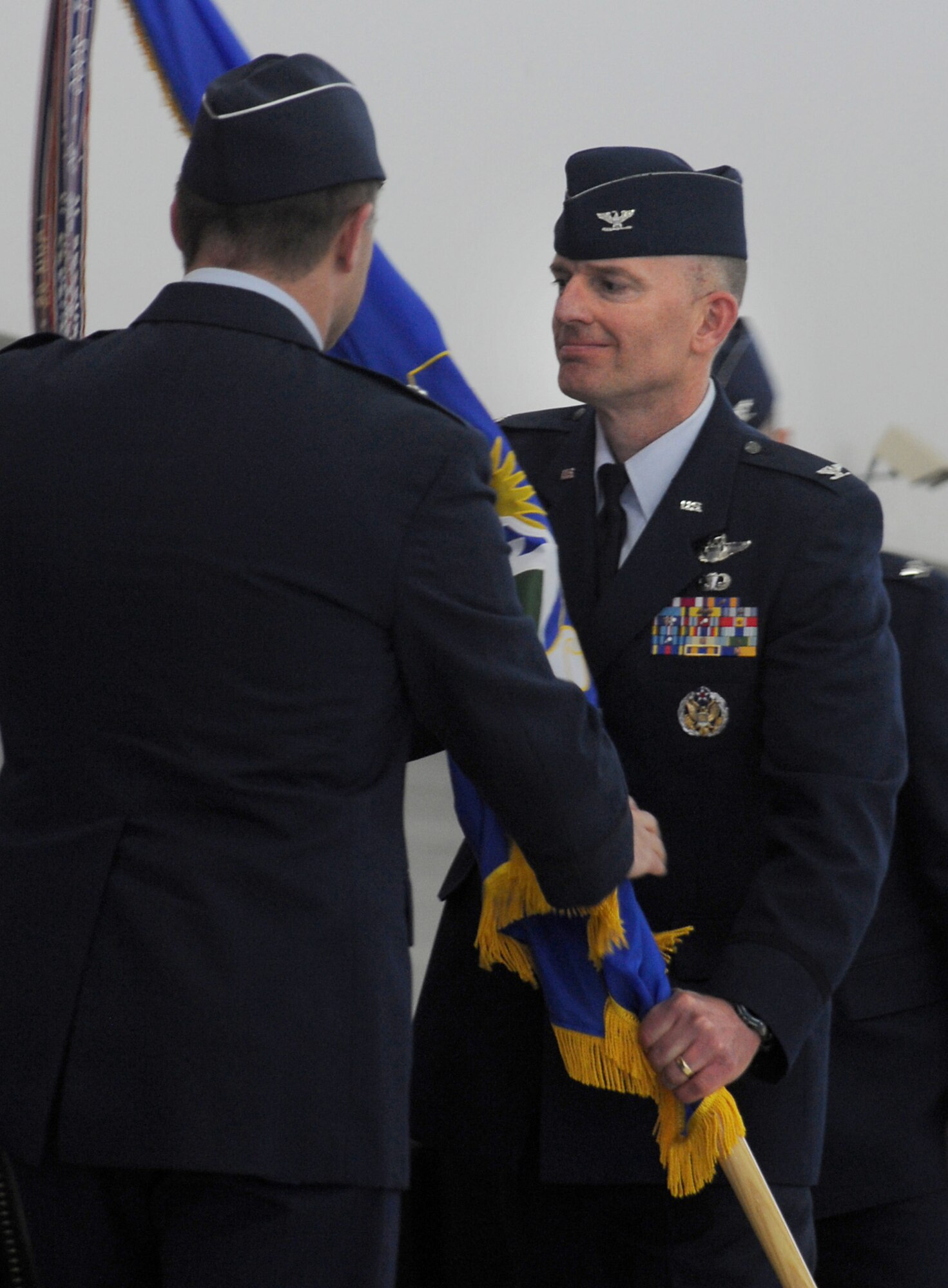 U.S. Air Force Paul T. Fitzgerald, incoming commander 142nd Fighter Wing, right, receives the guide on colors from Brig. Gen. Michael E. Stencel, commander Oregon Air National Guard, left, during the Change of Command ceremony held Feb. 7, 2015, Portland Air National Guard Base, Ore. Fitzgerald is a command pilot with over 2,200 flight hours in the F-15 Eagle. (U.S. Air National Guard photo by Staff Sgt. Brandon Boyd, 142nd Fighter Wing Public Affairs)