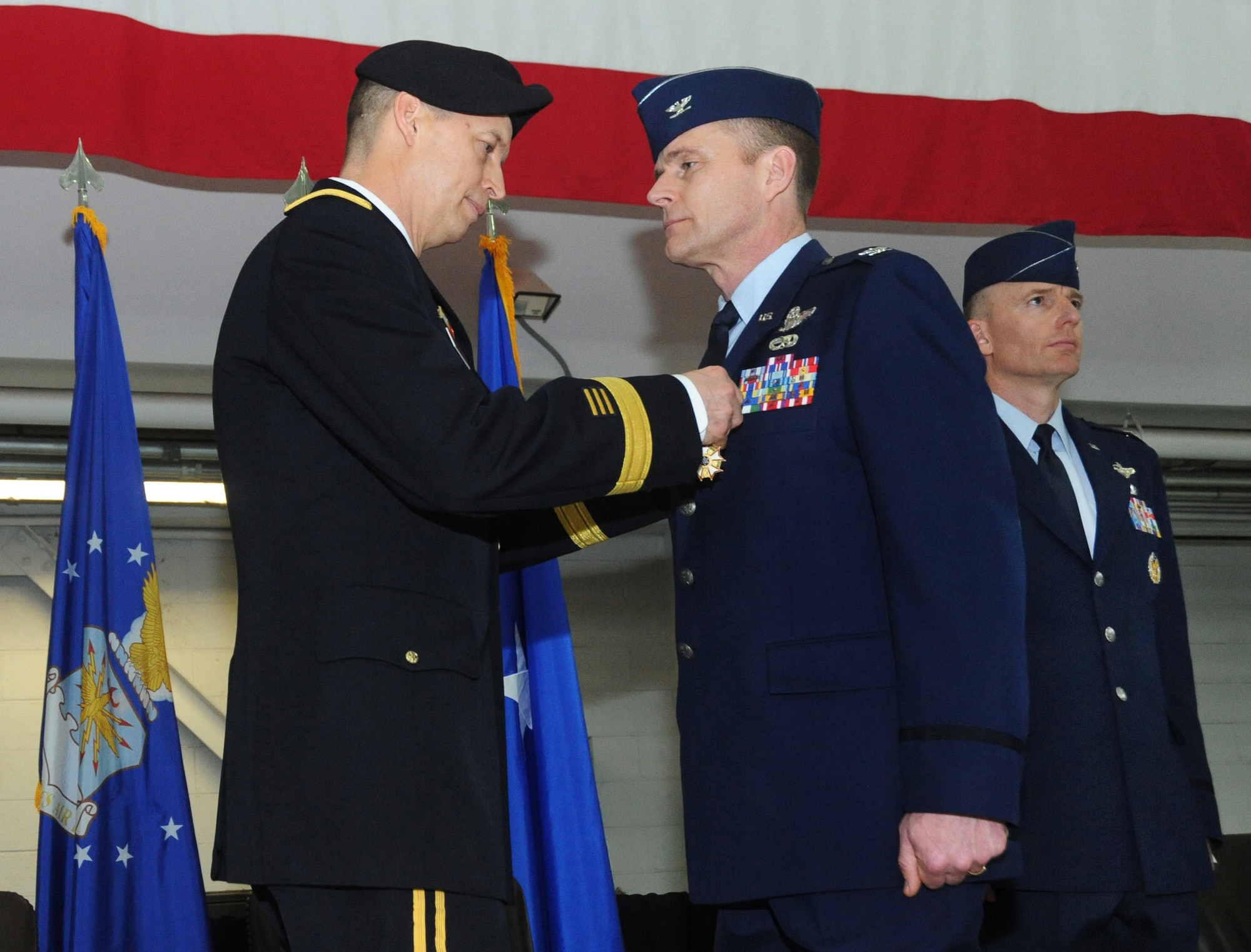 U.S. Air Force Col. Richard W. Wedan, outgoing commander 142nd Fighter Wing, right, is presented with The Legion of Merit Medal from Army Maj. Gen. Daniel R. Hokansen, The Adjutant General, Oregon, left, during the Change of Command ceremony for the 142nd Fighter Wing, Feb. 7, 2015, Portland Air National Guard Base, Ore. (U.S. Air National Guard photo by Tech. Sgt. John Hughel, 142nd Fighter Wing Public Affairs)
