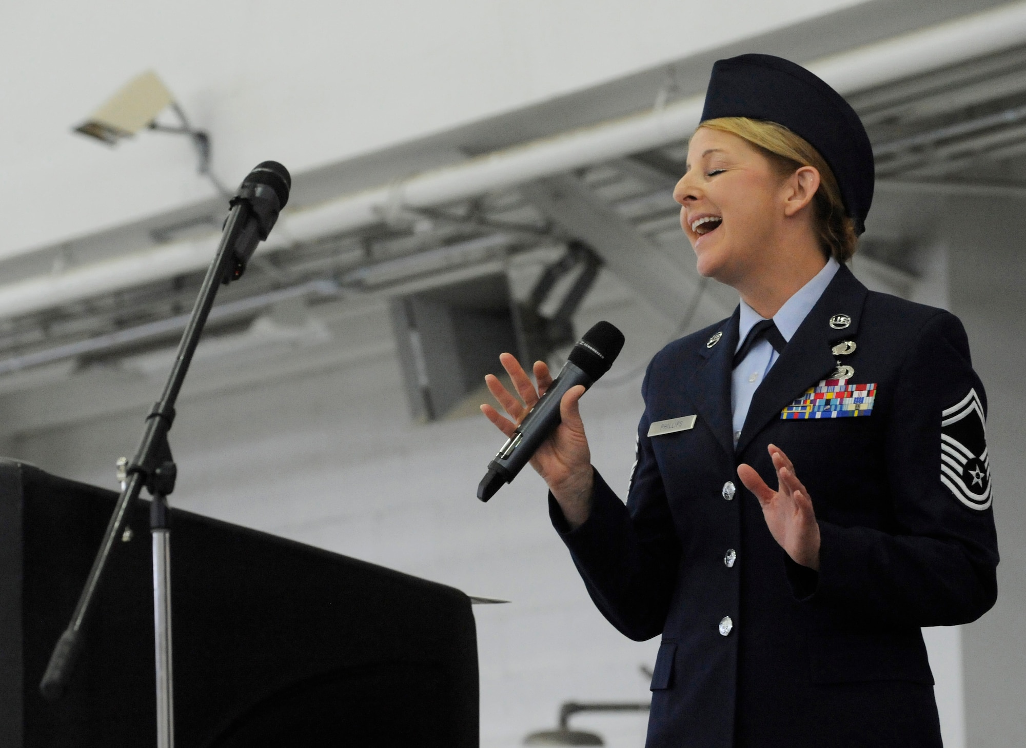 Senior Master Sgt. Denise Phillips, assigned to the 142nd Fighter Wing Mission Support Group, sings the National Anthem during the Change of Command ceremony held Feb. 7, 2015, Portland Air National Guard Base, Ore. Col. Paul T. Fitzgerald assumed command of the wing as Col. Richard W. Wedan retired after more than 27 years of service in the U.S. Air Force. (U.S. Air National Guard photo by Tech. Sgt. John Hughel, 142nd Fighter Wing Public Affairs)