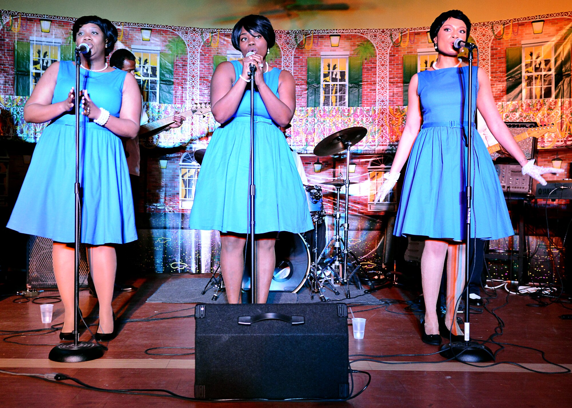 Girls’ Night Out, a local singing group, performs blues-rock music with the Black White Blues, a local blues band, during the Mardi Gras celebration at Fort Eustis, Va., Feb. 6, 2015. The Joint Base Langley-Eustis force support team hosts activities for many community events, including the Valentine’s Day scramble and the “Fit to Win Fitness Challenge.” (U.S. Air Force photo by Airman 1st Class Devin Scott Michaels/Released)