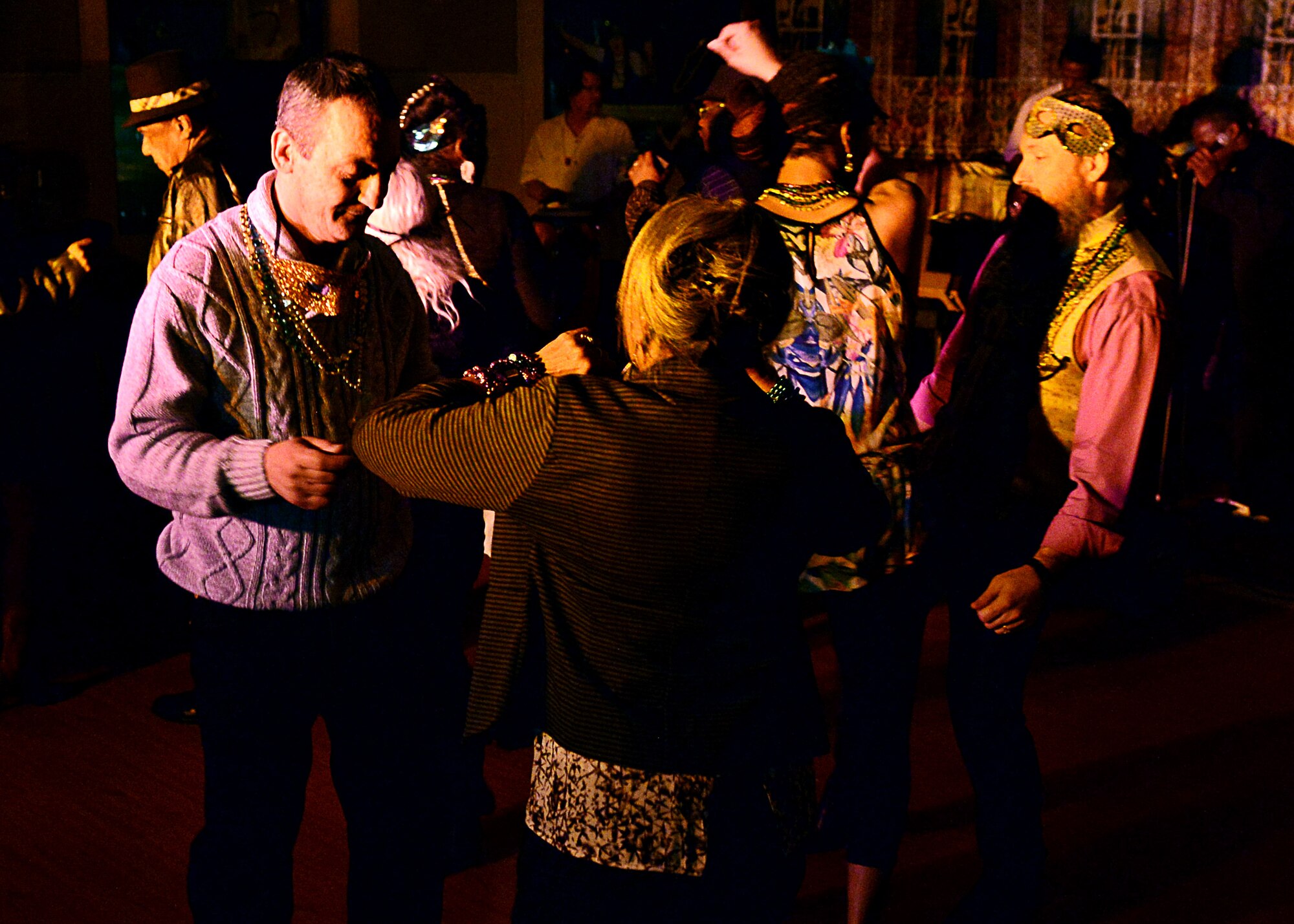 Joint Base Langley-Eustis community members dance to music played by the Black White Blues during the Mardi Gras celebration at Fort Eustis, Va., Feb. 6, 2015. The JBLE force support team’s motto is “For your morale, welfare and recreation.” (U.S. Air Force photo by Airman 1st Class Devin Scott Michaels/Released)