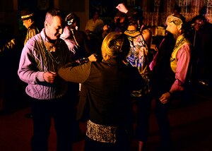 Joint Base Langley-Eustis community members dance to music played by the Black White Blues during the Mardi Gras celebration at Fort Eustis, Va., Feb. 6, 2015. The JBLE force support team’s motto is “For your morale, welfare and recreation.” (U.S. Air Force photo by Airman 1st Class Devin Scott Michaels/Released)