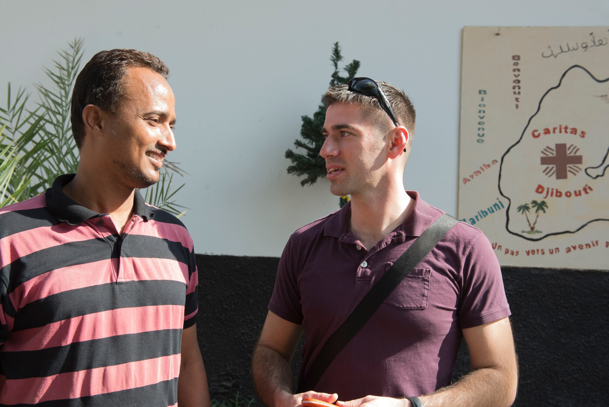 DJIBOUTI -- Capt. Jonathan St. Peter, African Partnership Flight French interpreter, (right) speaks with a caretaker while on assignment for African Partnership Flight at the Caritas Center, which cares for refugee children, Djibouti Feb. 8, 2015. African Partnershp Flight-Djibouti is designed to strengthen relationships between Burundi, Djibouti, Kenya, Tanzania and Uganda. (U.S. Air Force photo/Tech. Sgt. Benjamin Wilson)