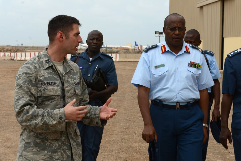 DJIBOUTI -- Capt. Jonathan St. Peter, African Partnership Flight French interpreter, (left) translates for East African air chiefs while on assignment for African Partnership Flight on Djibouti Air Base, Djibouti, Feb. 8, 2015. African Partnershp Flight-Djibouti is designed to strengthen relationships between Burundi, Djibouti, Kenya, Tanzania and Uganda. (U.S. Air Force photo/Tech. Sgt. Benjamin Wilson)