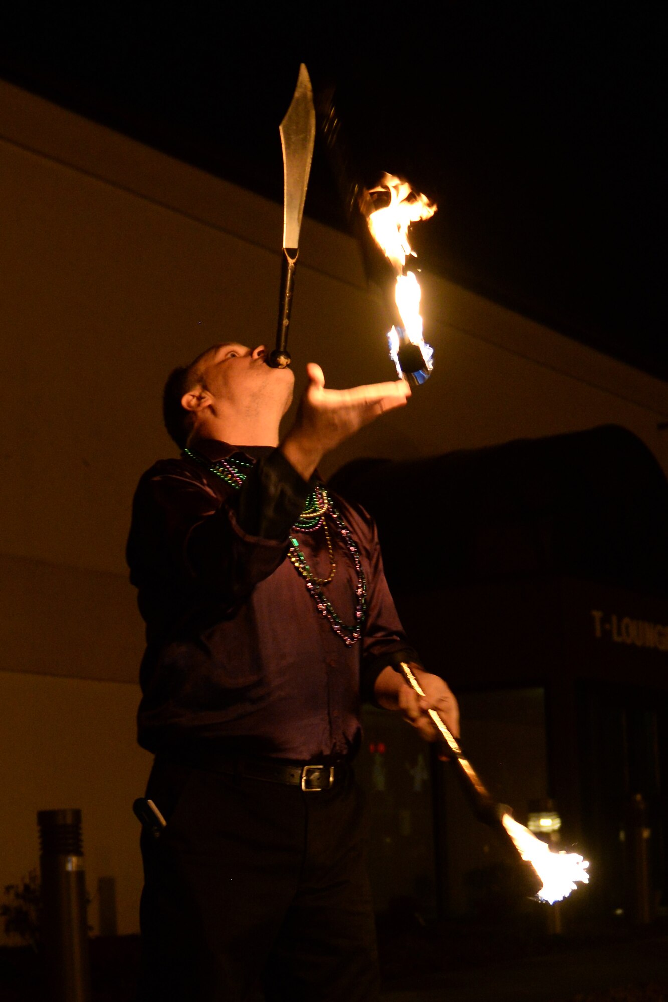 Randy Chapman juggles knives and fire during the Mardi Gras event at Fort Eustis, Va., Feb. 6, 2015. The event also included two bands and traditional Cajun style food. (U.S. Air Force photo by Staff Sgt. Teresa J. Cleveland/Released)