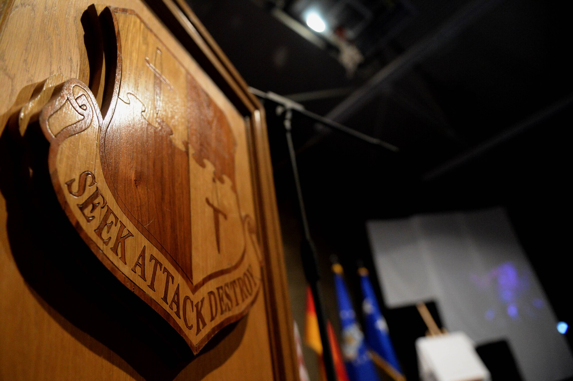 The 52nd Fighter Wing shield is displayed on a podium during the 52 FW 2014 Annual Awards Banquet at the Skelton Memorial Fitness Center at Spangdahlem Air Base, Germany, Feb. 7, 2015. Nominees were recognized for their work and performance at the 2014 Annual Awards. (U.S. Air Force photo by Airman 1st Class Timothy Kim/Released)