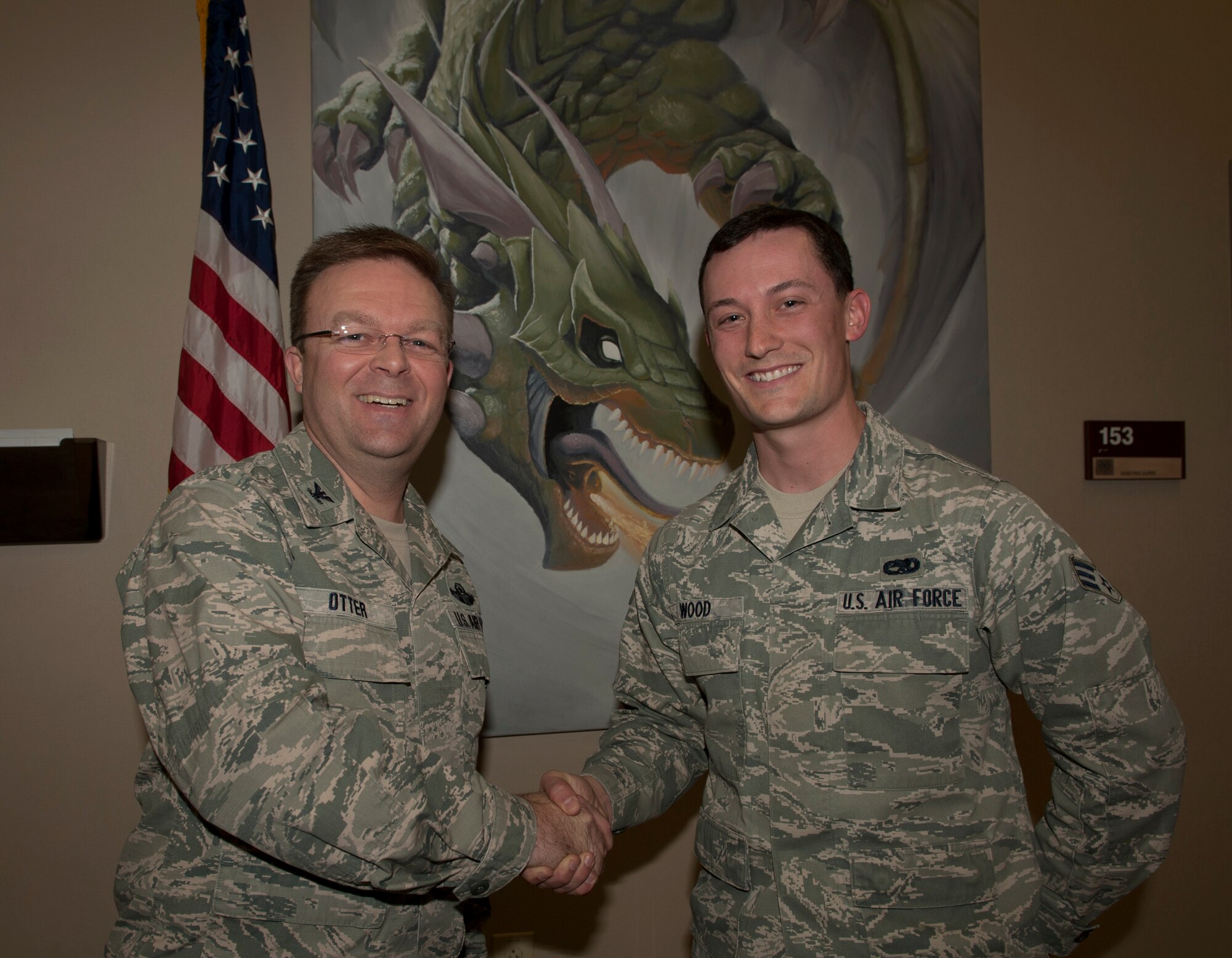 Col. William Otter, 19th Airlift Wing vice commander, congratulates Senior Airman Brandon Wood, a 19th Aircraft Maintenance Squadron unit training monitor, for his selection as Combat Airlifter of the Week Feb. 3, 2015, at Little Rock Air Force Base, Ark. Wood volunteered 46 hours to his community, squadron, and wing level holiday events. (U.S. Air Force photo by Airman 1st Class Scott Poe) 