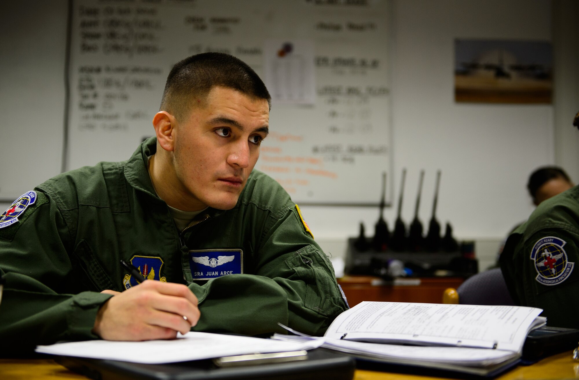 Senior Airman Juan Arce, 86th Aeromedical Evacuation Squadron technician, listens to a preflight briefing at Ramstein Air Base, Germany, Feb. 6, 2015. Arce and other 86th AES members took to the skies to test and hone their skills during a check ride sortie. (U.S. Air Force photo/Senior Airman Armando A. Schwier-Morales) 