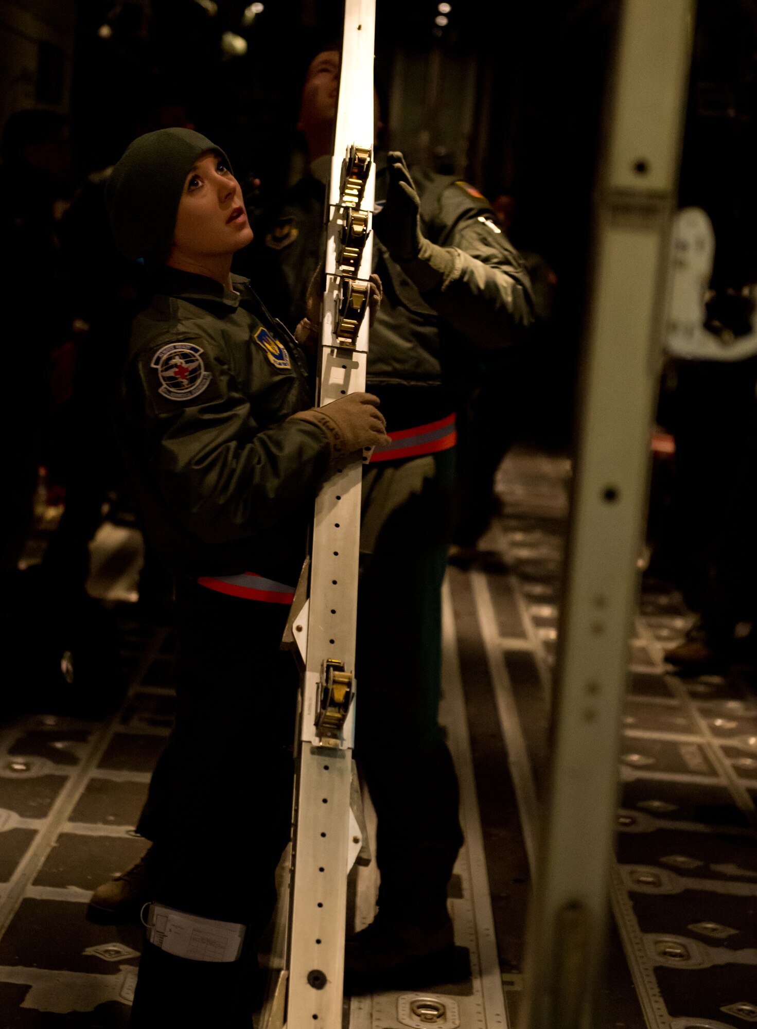 Staff Sgt. Kelsey Carli, 86th Aeromedical Evacuation Squadron technician, installs a station to hold up litters at Ramstein Air Base, Germany, Feb. 6, 2015. Carli is configuring a C-130J Super Hercules for an aeromedical evacuation training sortie. (U.S. Air Force photo/Senior Airman Armando A. Schwier-Morales) 