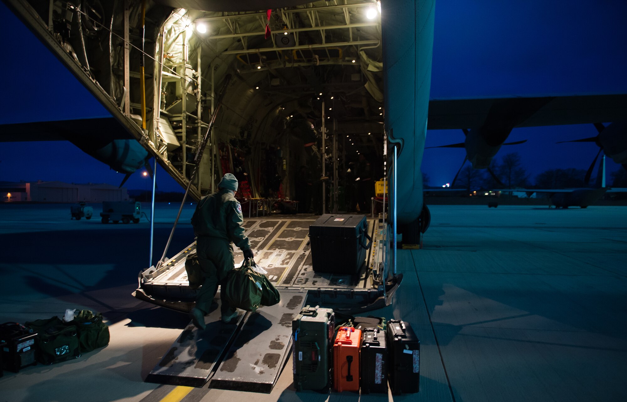 Senior Airman Michelle Burns, 86th Aeromedical Evacuation Squadron ground team member, carries equipment onto a C-130J Super Hercules at Ramstein Air Base, Germany, Feb. 6, 2015. The 86th AES transport patients from combat zones or natural disasters to larger medical facilities. (U.S. Air Force photo/Senior Airman Armando A. Schwier-Morales) 