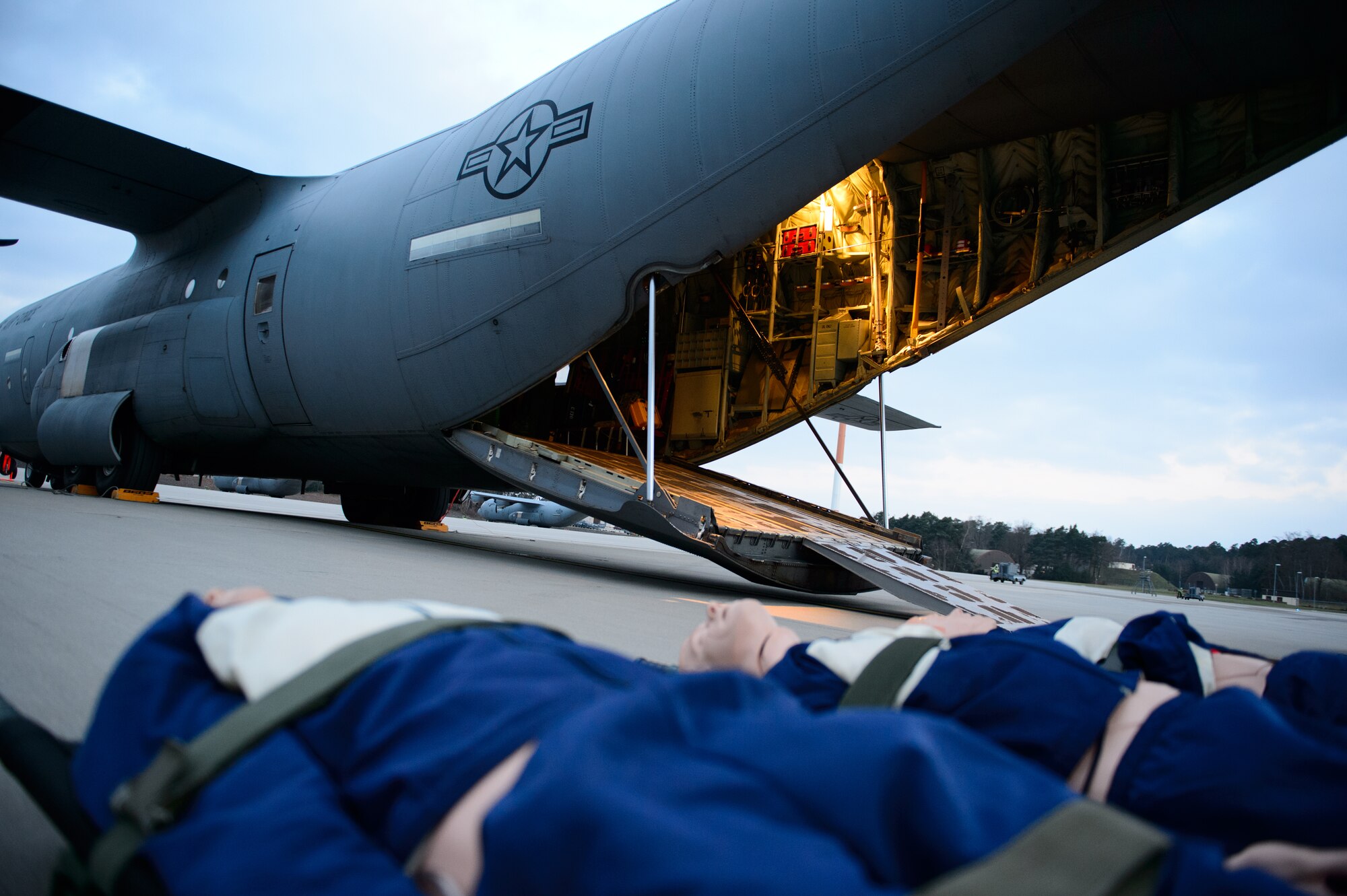 Mannequins sit on the flightline awaiting their ride on a C-130J Super Hercules as part of a training sortie for the 86th Aeromedical Evacuation Squadron at Ramstein Air Base, Germany, Feb. 6, 2015. Using mannequins is just one of the ways the 86th AES ensures its training is as realistic as possible. (U.S. Air Force photo/Senior Airman Armando A. Schwier-Morales) 