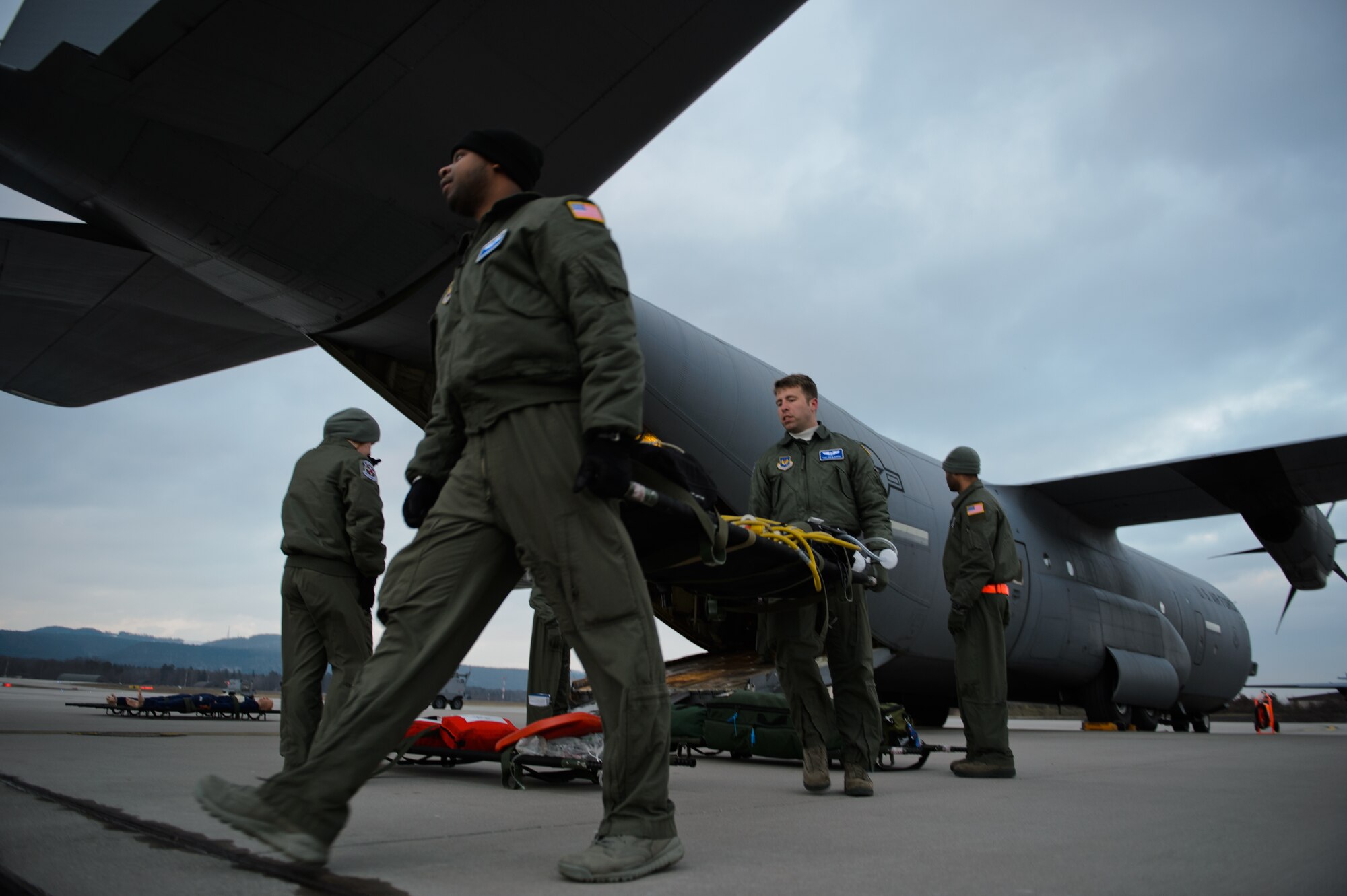 Staff Sgt. Nicholas Evans, 86th Aeromedical Evacuation Squadron ground crew member, left, and Staff Sgt. Drew Bivens, 86th AES technician, carry a litter with medical equipment onto a C-130J Super Hercules, Ramstein Air Base, Germany, Feb. 6, 2015. The 86th AES ensures their Airmen are ready to be called upon at any time with training sorties like the one Evans and Bivens participated in. (U.S. Air Force photo/Senior Airman Armando A. Schwier-Morales) 