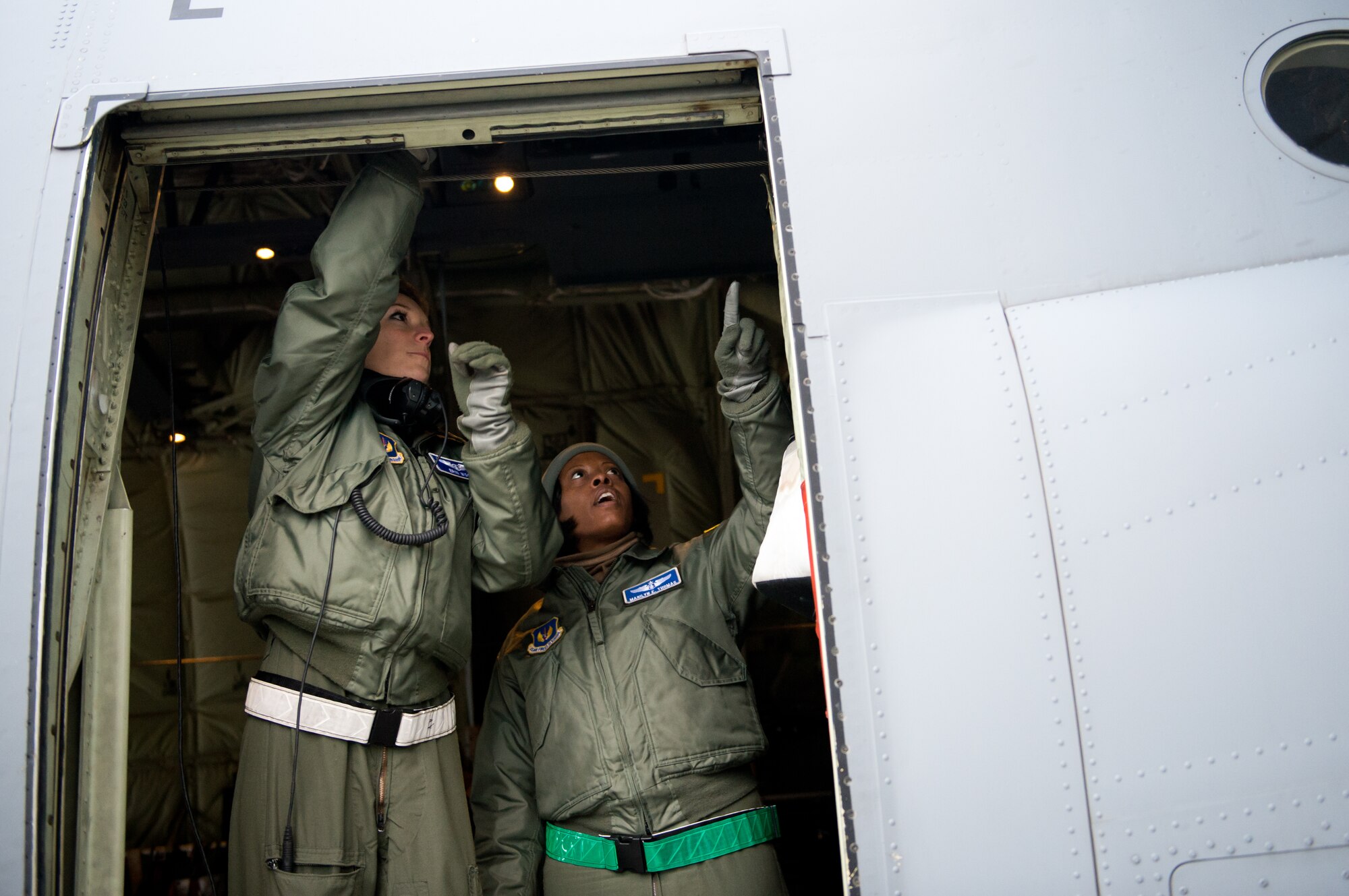 Capt. Erin Wood, 86th Aeromedical Evacuation Squadron flight nurse, and Lt. Col. Marilyn Thomas, 86th AES evaluator, discuss emergency evacuation procedures at Ramstein Air Base, Germany, Feb. 6, 2015. Wood and the aeromedical evacuation crew members are required to know and understand the aircraft to ensure proper care for their patients. (U.S. Air Force photo/Senior Airman Armando A. Schwier-Morales) 