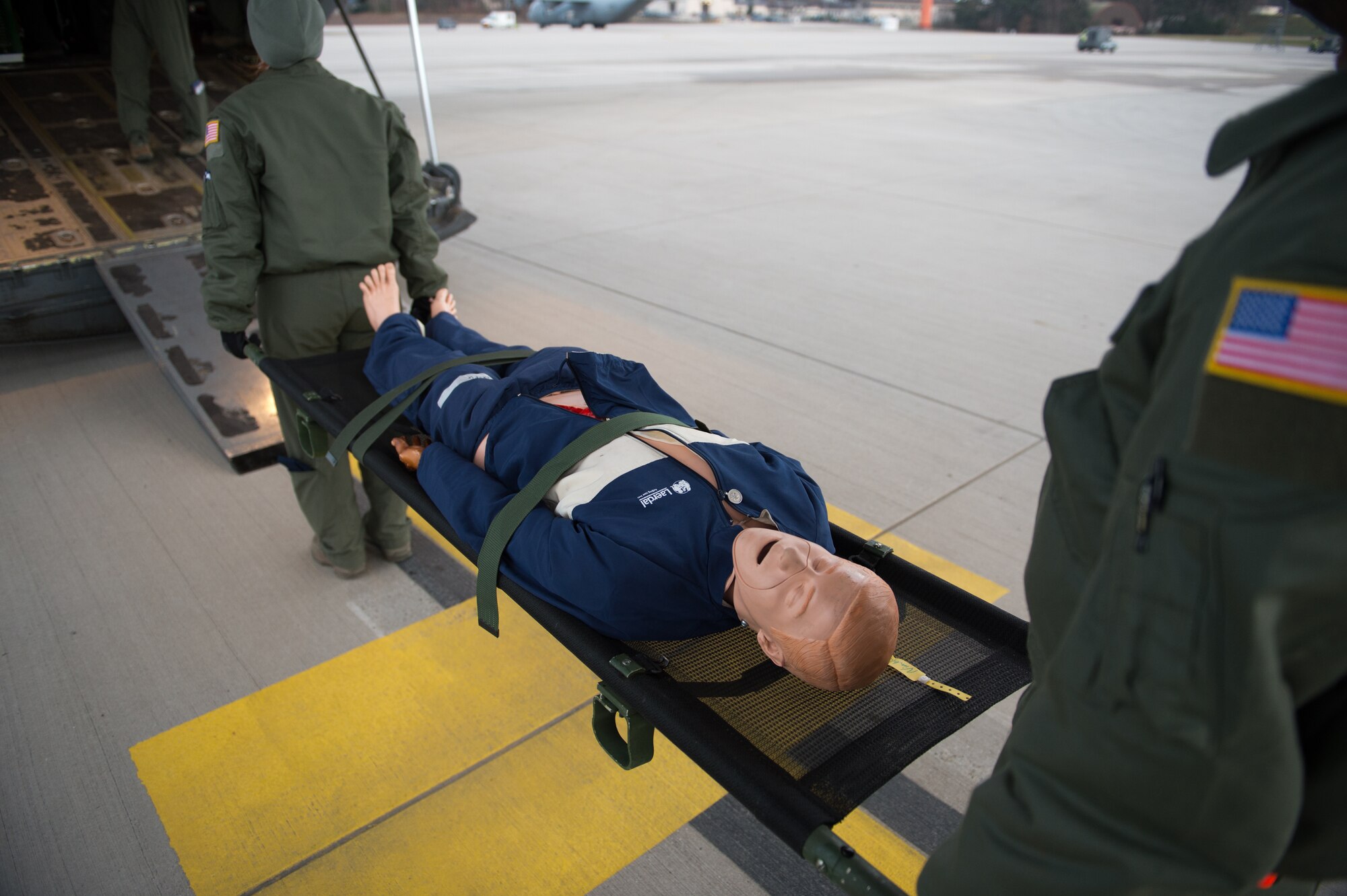 A mannequin is loaded onto an aircraft during a training sortie with the 86th Aeromedical Evacuation Squadron at Ramstein Air Base, Germany, Feb. 6, 2015. Training sorties ensure Airmen are ready to tackle any situation that may arise as they transport patients.  (U.S. Air Force photo/Senior Airman Armando A. Schwier-Morales)