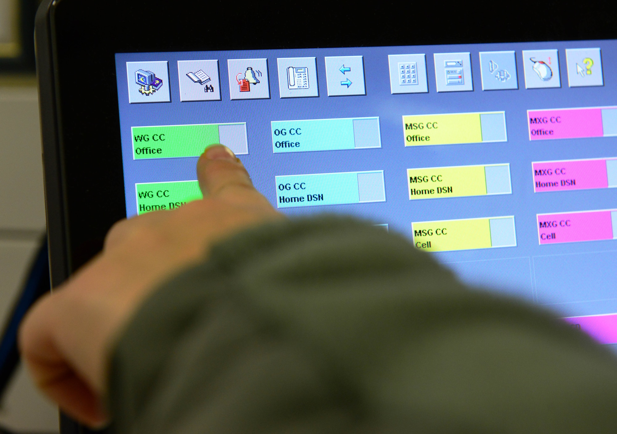U.S. Air Force Tech. Sgt. May Scimone, 31st Fighter Wing Command Post systems NCO in charge, calls the wing commander about a notification, Feb. 9, 2015, at Aviano Air Base, Italy. Command post Airmen are responsible for monitoring all base notifications, to include ensuring the wing commander is aware of all situations. (U.S. Air Force photo by Senior Airman Matthew Lotz/Released)