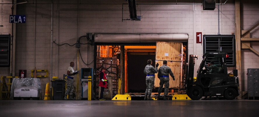 Airmen from the 437th Aerial Port Squadron build a pallet Feb. 9, 2015, at the 437th APS on Joint Base Charleston, S.C. The “Port Dawgs” work through the night to process cargo and load it on and off Charleston’s fleet of C-17 Globemaster IIIs. (U.S. Air Force photo/Airman 1st Class Clayton Cupit) 
