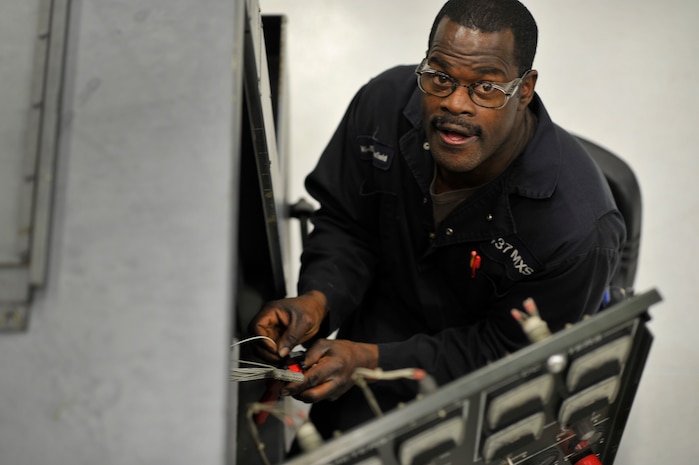 Paul Mansfield, an aerospace ground equipment technician with the 437th Maintenance Squadron, repairs electrical plugs on an essex generator at Joint Base Charleston, S.C., Feb. 9, 2015. The majority of the 437 MXS works around the clock to ensure mission success. (U.S. Air Force photo/Tech. Sgt. Renae Pittman)