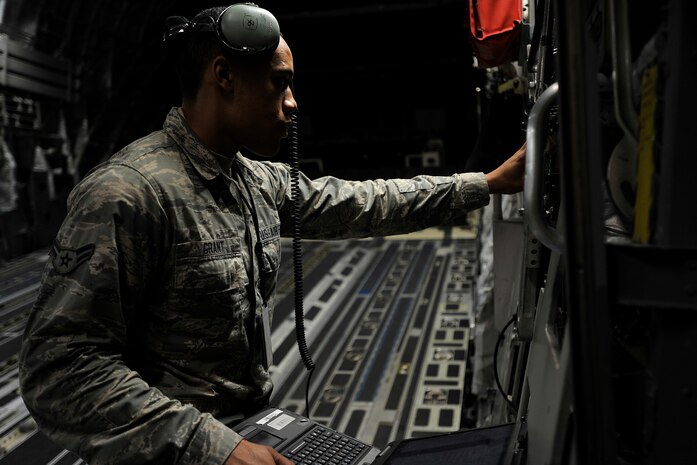 Airman 1st Class Cornelius Grant, a crew chief with the 437th Aircraft Maintenance Squadron, opens the cargo ramp door to troubleshoot problems with the nose strut of the C-17 Globemaster III at Joint Base Charleston, S.C., Feb. 9, 2015. Grant maintains aircraft structures, systems, components, and support equipment--all while working swing shift. Swing shift for Grant lasts from 3 p.m. to 11 p.m. (U.S. Air Force photo/Tech. Sgt. Renae Pittman)