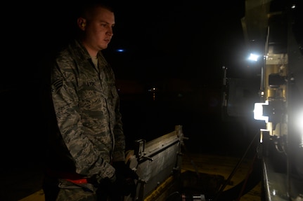 Senior Airman Eric Lydic, a fuels technician with the 628th Logistics Readiness Squadron, monitors pressure gauges during a refueling operation at Joint Base Charleston, S.C., Feb. 9, 2015. The fuels section is one of multiple units on base that work around the clock, no matter the weather, to ensure the mission accomplishment. (U.S. Air Force photo/Tech. Sgt. Renae Pittman)