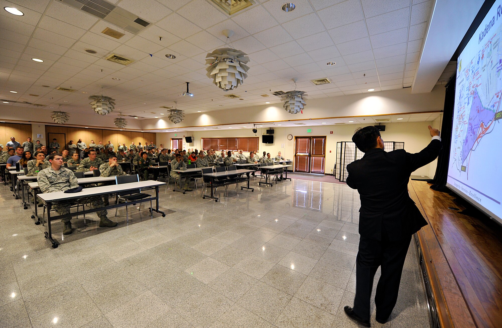 Hideaki Sakihama, 18th Wing Public Affairs community relations specialist, briefs about the Okinawa Marathon, to be held on Feb. 15, to volunteers at the Schilling Community Center on Kadena Air Base, Japan, Feb. 9, 2015. Approximately 13,000 people will be participating in the 23rd Okinawa Marathon and more than 250 volunteers from Team Kadena will be supporting them. (U.S. Air Force photo by Naoto Anazawa)