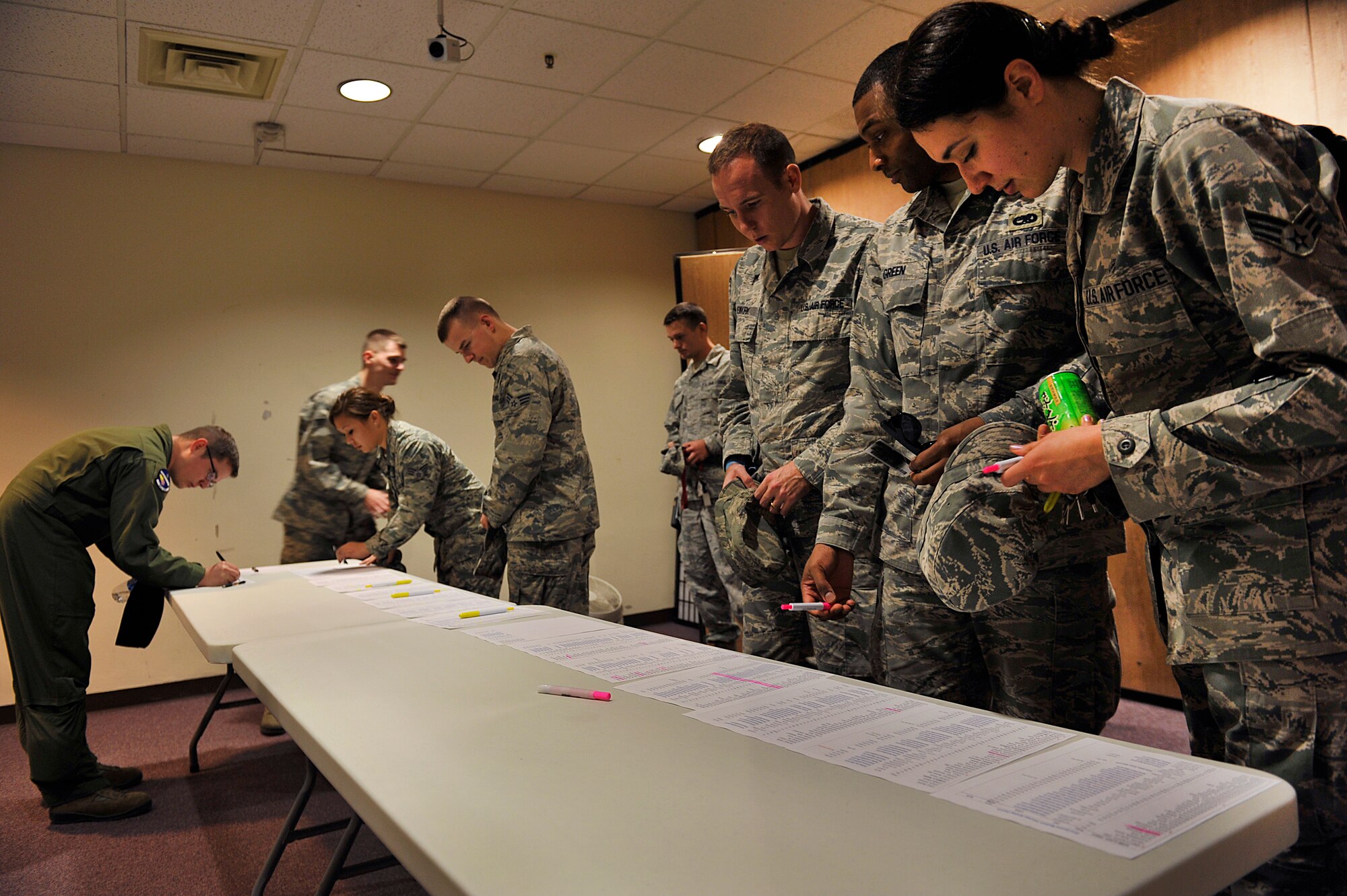 Volunteers sign in before the Okinawa Marathon brief at the Schilling Community Center on Kadena Air Base, Japan, Feb. 9, 2015. More than 250 volunteers will be between Gates 2 and 5 supporting and cheering on the approximately 13,000 runners in the 23rd Okinawa Marathon. (U.S. Air Force photo by Naoto Anazawa)