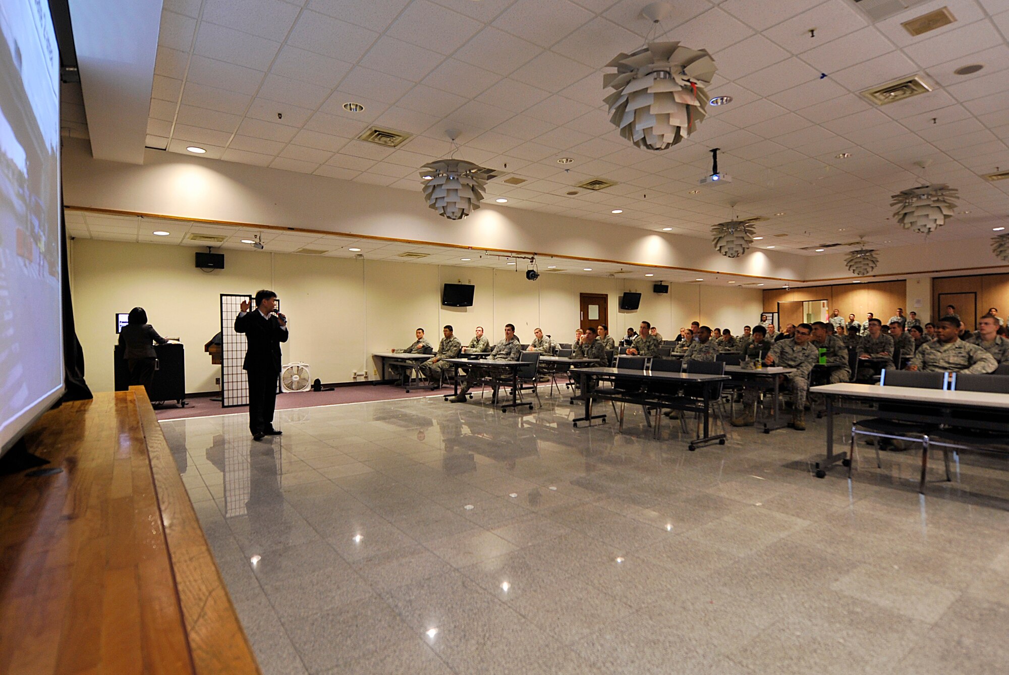 Hideaki Sakihama, 18th Wing Public Affairs community relations specialist, briefs about the Okinawa Marathon held on Feb. 15 to volunteers at the Schilling Community Center on Kadena Air Base, Japan, Feb. 9, 2015. Kadena has supported the Okinawa Marathon for 23 years with hundreds of volunteers each year. Okinawa Marathon is the only marathon in Japan which includes route through a U.S. Military installation. (U.S. Air Force photo by Naoto Anazawa)