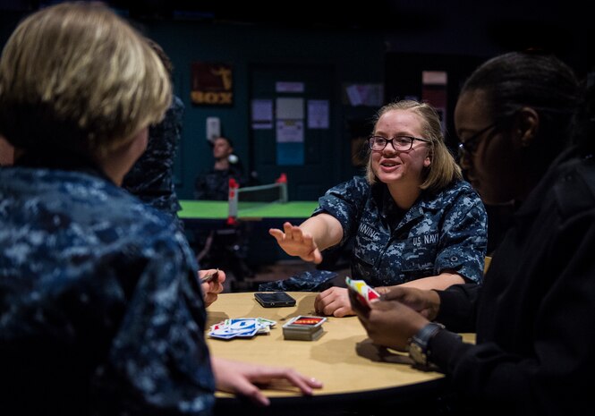 Electronics Technician Kelcey Romning, Naval Nuclear Power Training Command student, plays a card game with fellow Sailors in the Bowman Center Feb. 9, 2015, at Joint Base Charleston – Weapons Station. The Bowman Center provides morale, recreation and welfare opportunities for Sailors late into the night.(U.S. Air Force photo/ Senior Airman Dennis Sloan)